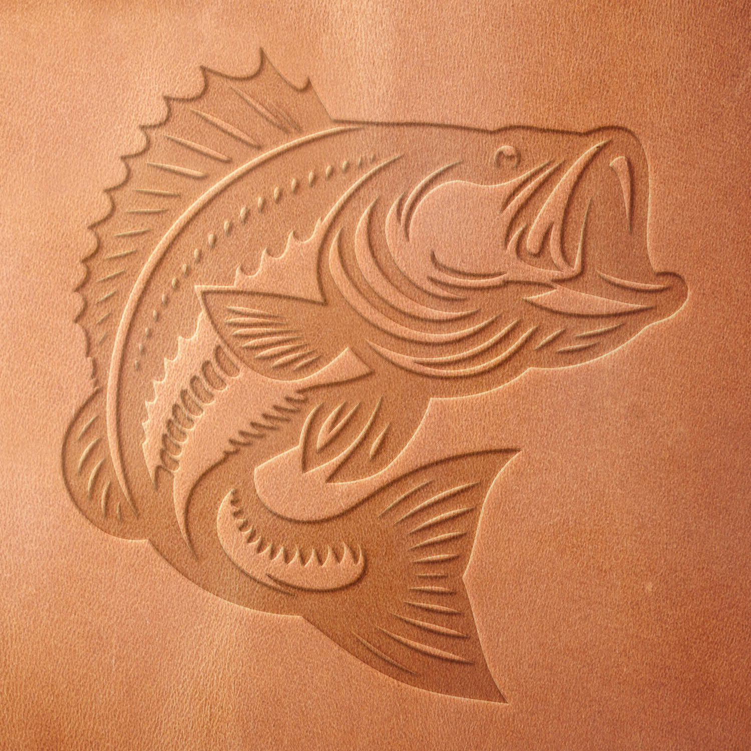 Leather sample showcasing a stamped bass fish design using a delrin leather stamp, emphasizing the fish’s scaly texture and energetic pose.
