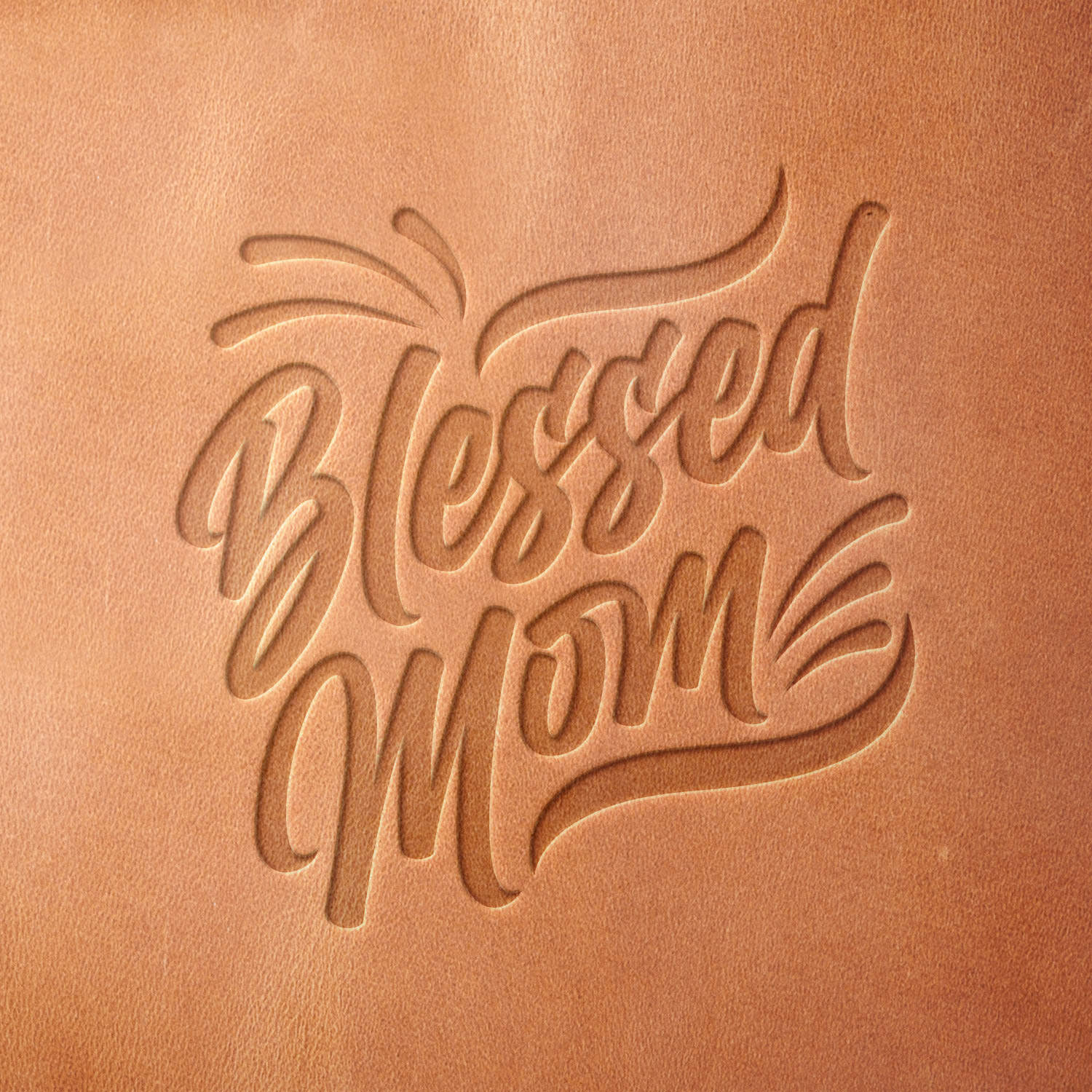 Leather piece stamped with a Delrin leather stamp featuring the words “Blessed Mom” in a modern script—perfect for custom keychains, wallets, or handmade tags.