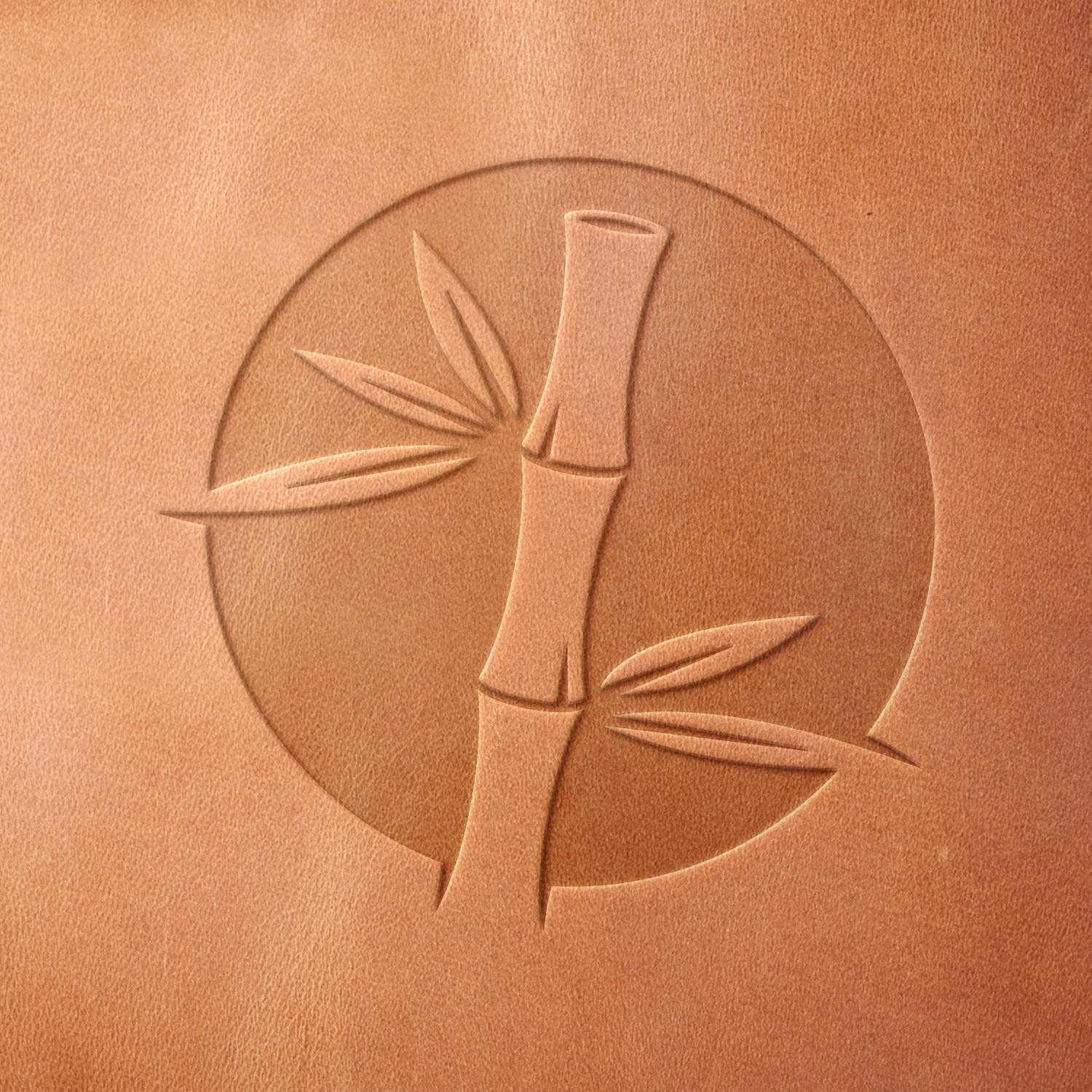 Leather piece stamped with a Delrin leather stamp of a bamboo stalk and leaves—ideal for adding a serene, botanical detail to wallets, journals, or handmade gifts.