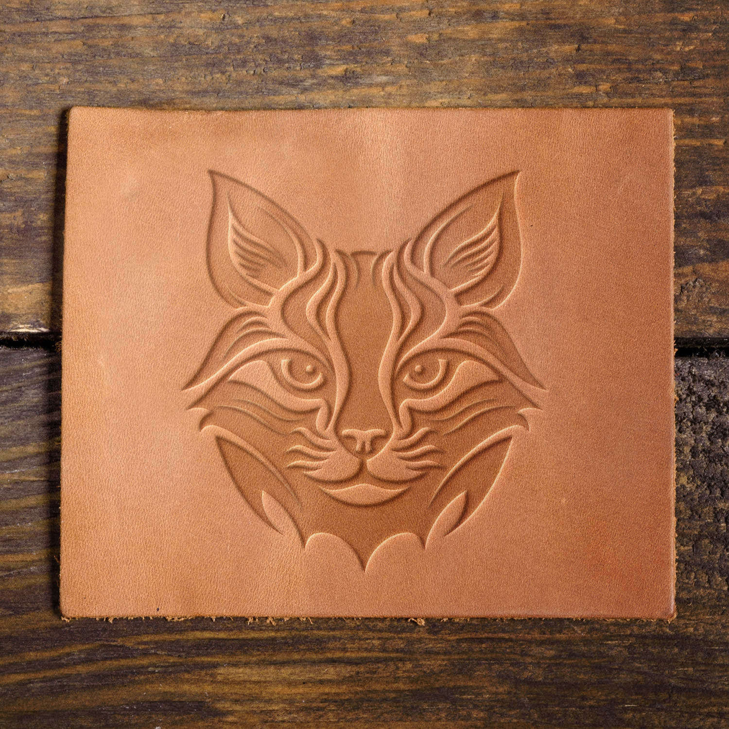 Leather sample with a striking lynx face stamp impression, adding a fierce and nature-inspired touch to leather projects.