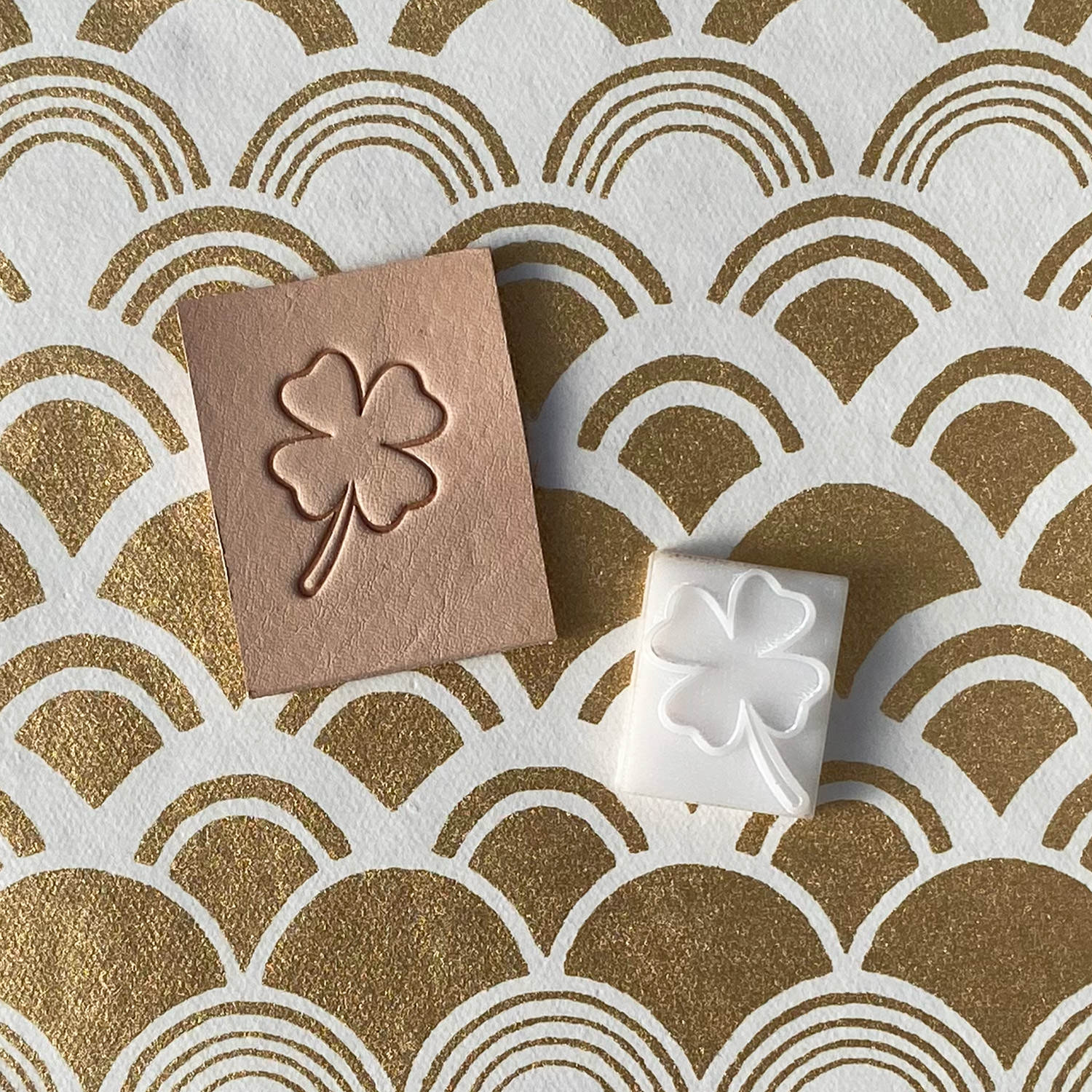 Leather sample showcasing a stamped four-leaf clover design using a delrin leather stamp, emphasizing its lucky symbolism and clean outline.