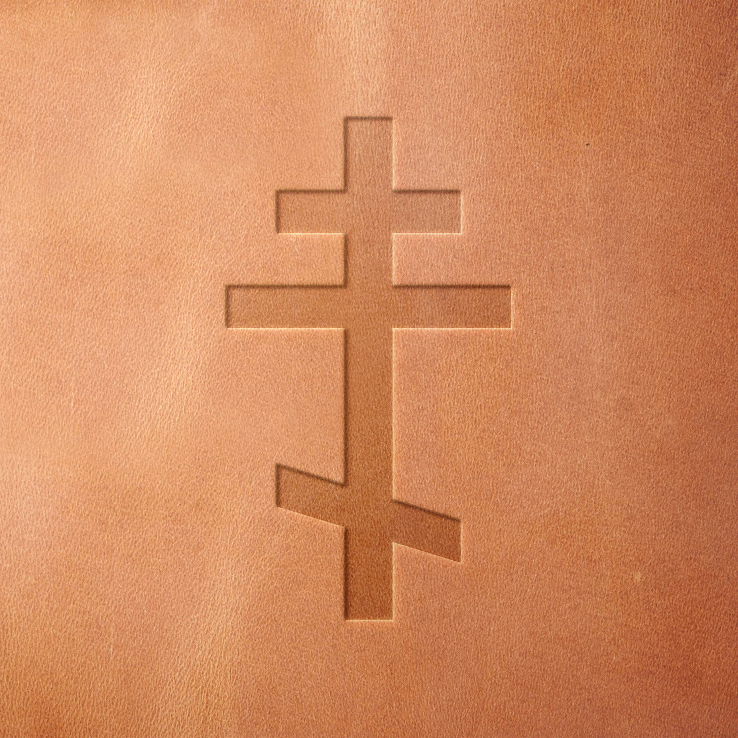 Leather piece stamped with a Delrin leather stamp of an Eastern Orthodox cross—great for handmade religious gifts, custom bookmarks, or heritage-inspired leather accessories.