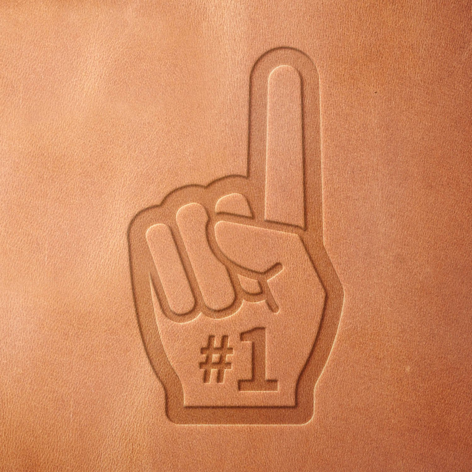 Leather sample showcasing a stamped sports foam finger design using a delrin leather stamp, emphasizing the bold outline and fan-favorite “#1” detail.