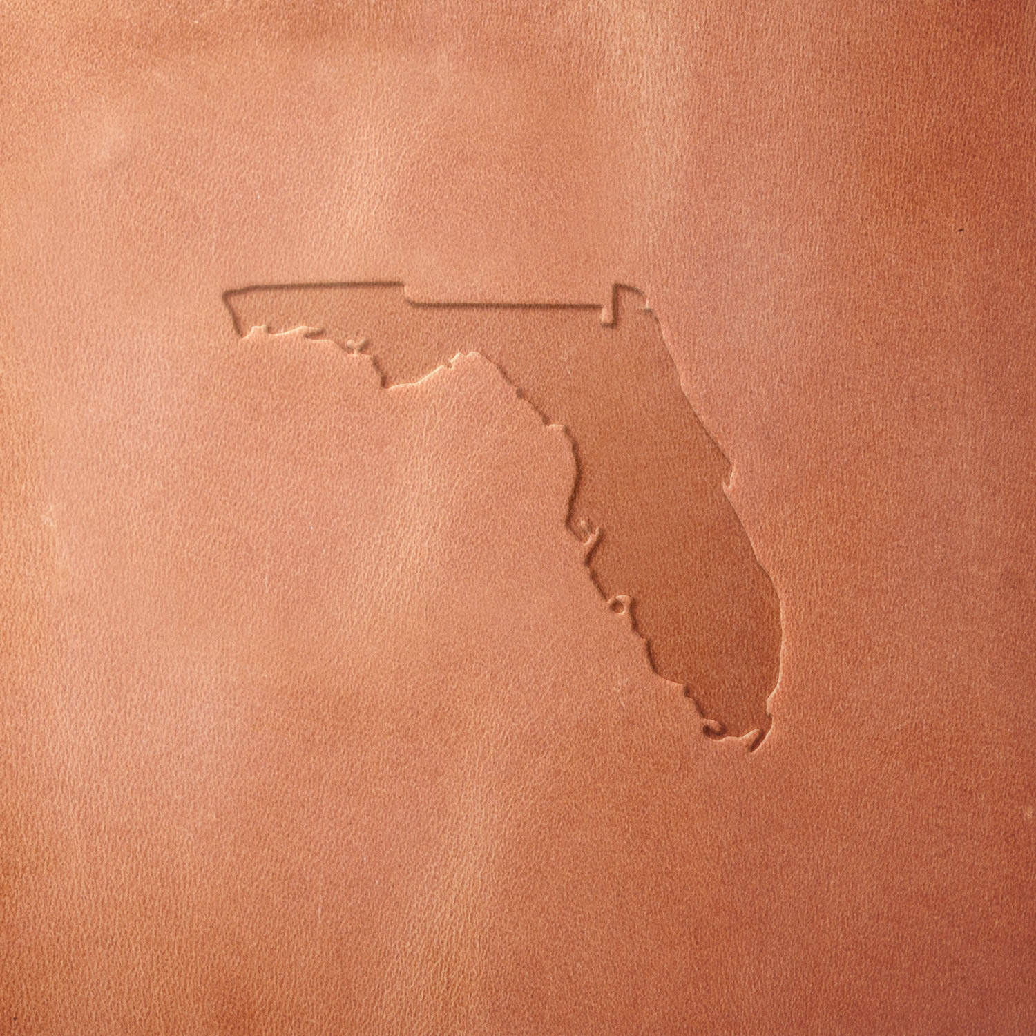 Leather sample featuring a stamped Florida state outline using a Delrin leather stamp, ideal for custom leather goods, souvenirs, and regional artwork.