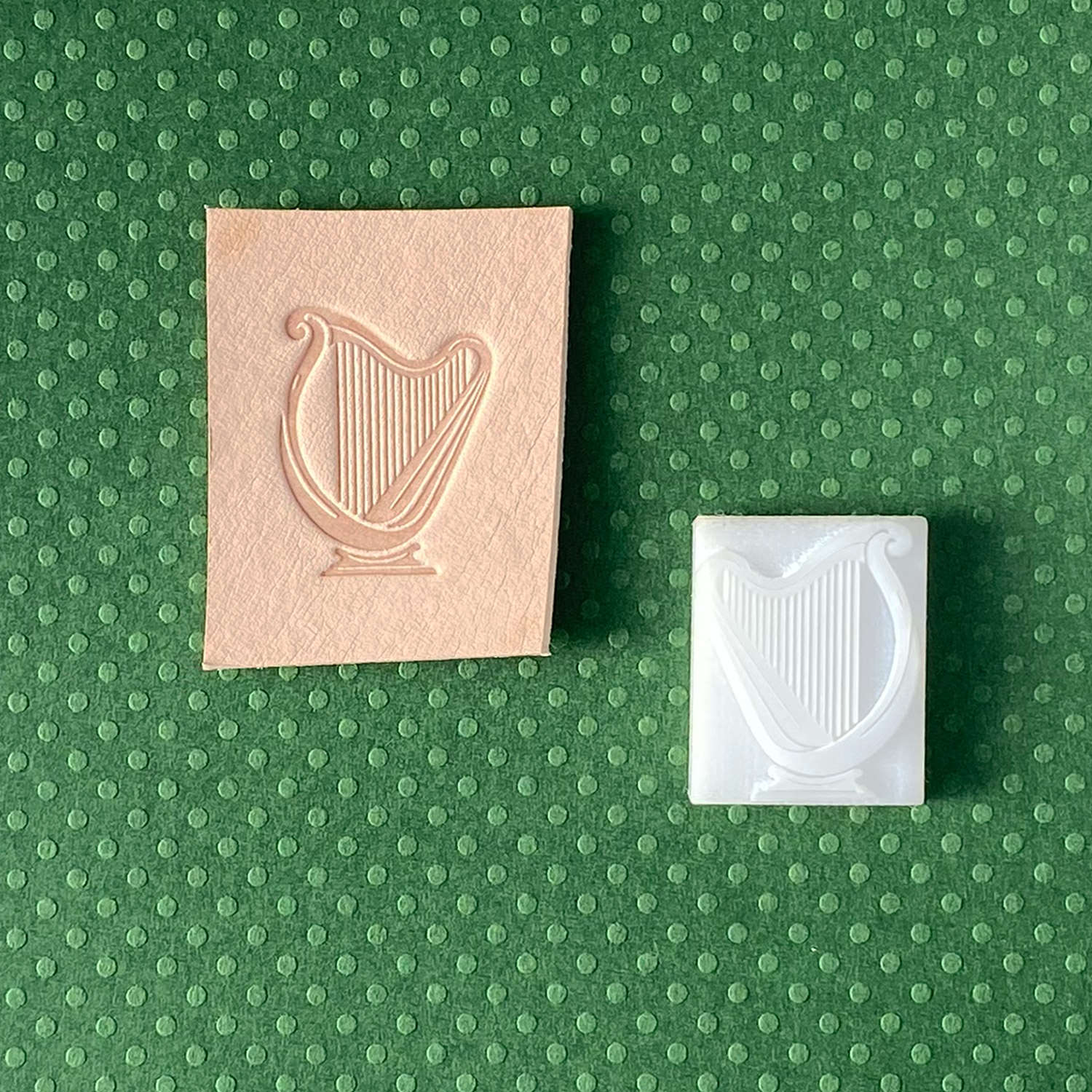 Leather sample with a finely detailed harp stamp impression, perfect for adding a musical and Celtic-inspired touch to leathercraft.