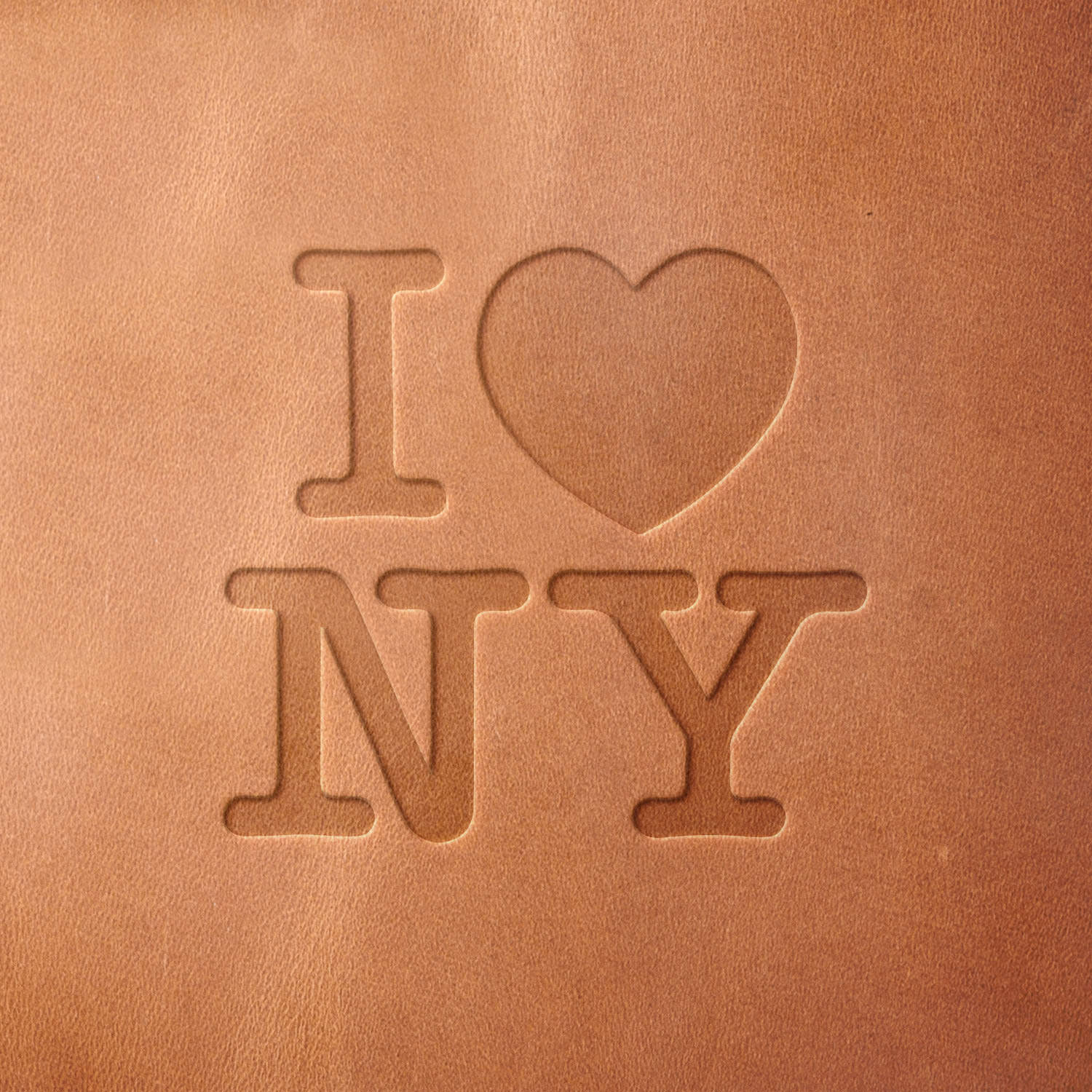 Leather sample with a crisp "I ♥ NY" stamp impression from a Delrin leather stamp, ideal for creating high-quality city and travel-themed leathercraft projects.
