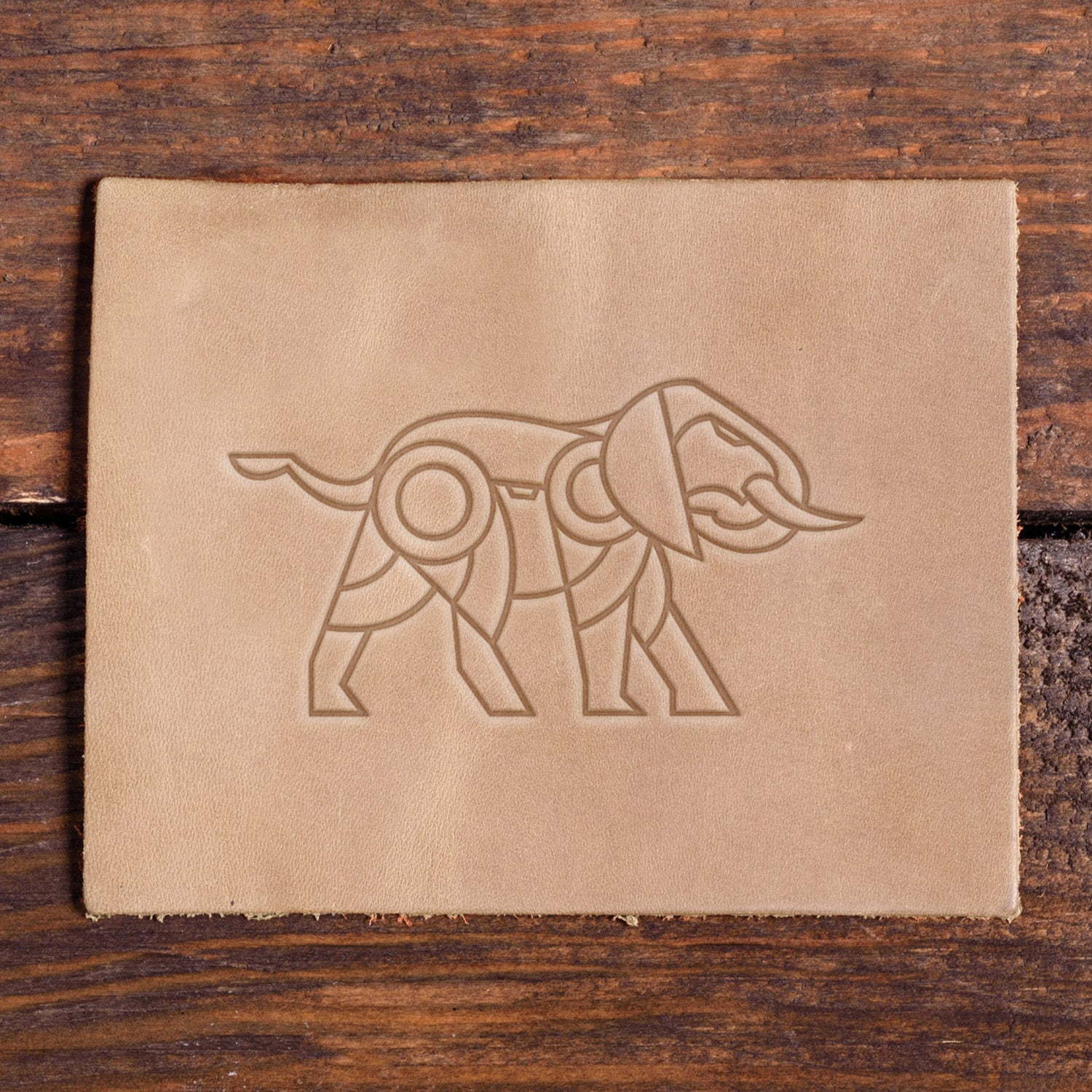 Stamped impression of a geometric elephant made with a Delrin leather stamp on natural veg-tan leather.