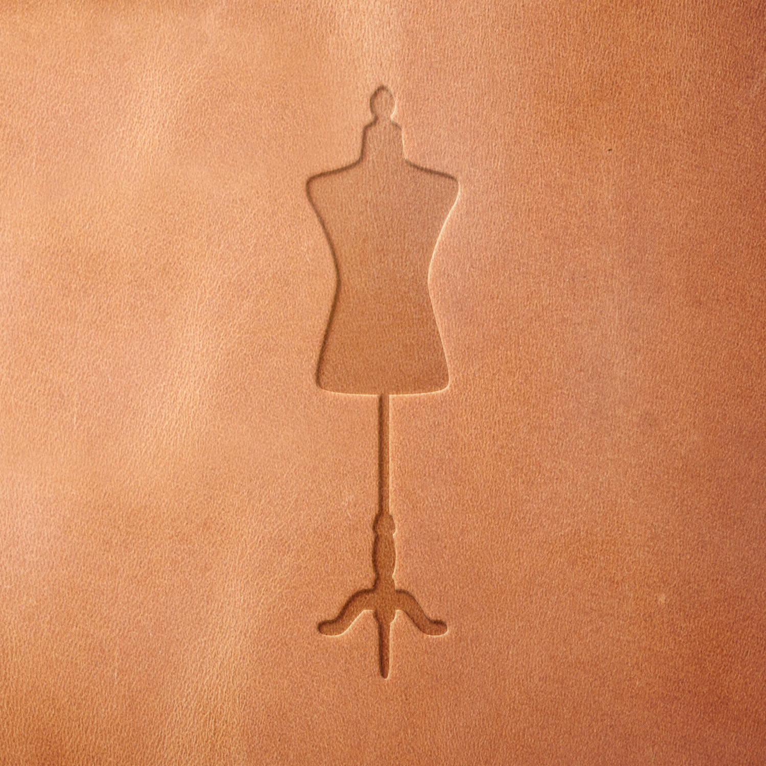 Leather piece stamped with a Delrin leather stamp of a classic mannequin—great for leather gifts for seamstresses, tailors, or fashion lovers.