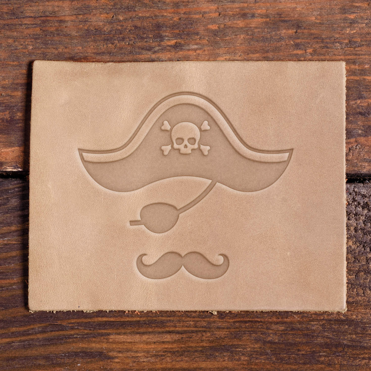 Leather-stamped pirate hat, pipe, and mustache made using a Delrin leather stamp