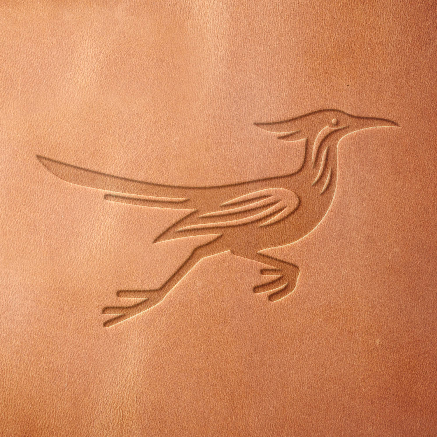 Leather piece stamped with a Delrin leather stamp of a running roadrunner—adds a dynamic Southwestern accent to wallets, belts, or handmade gifts.