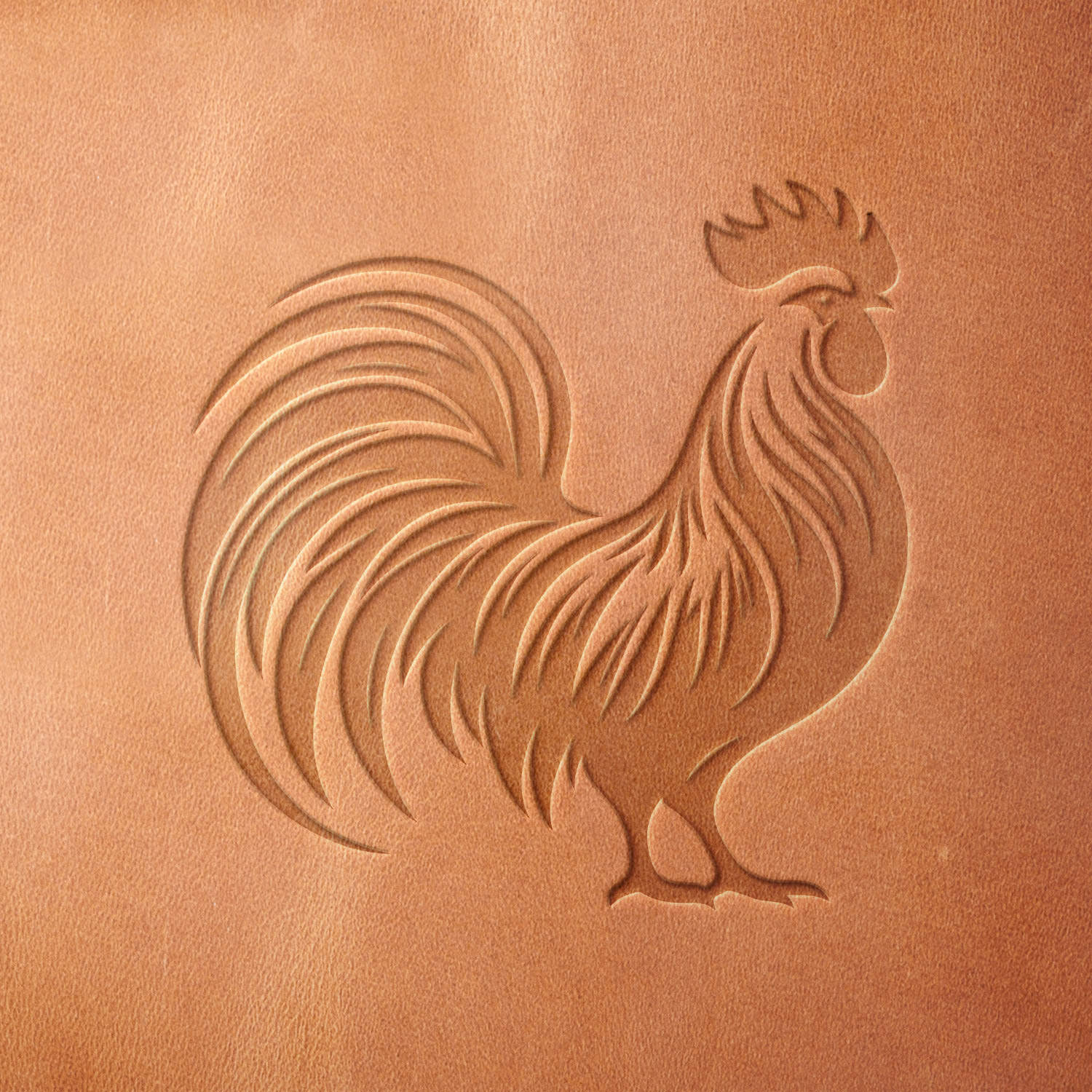 Leather piece stamped with a Delrin leather stamp of a stylized rooster—great for aprons, coasters, or handmade barnyard-themed goods.