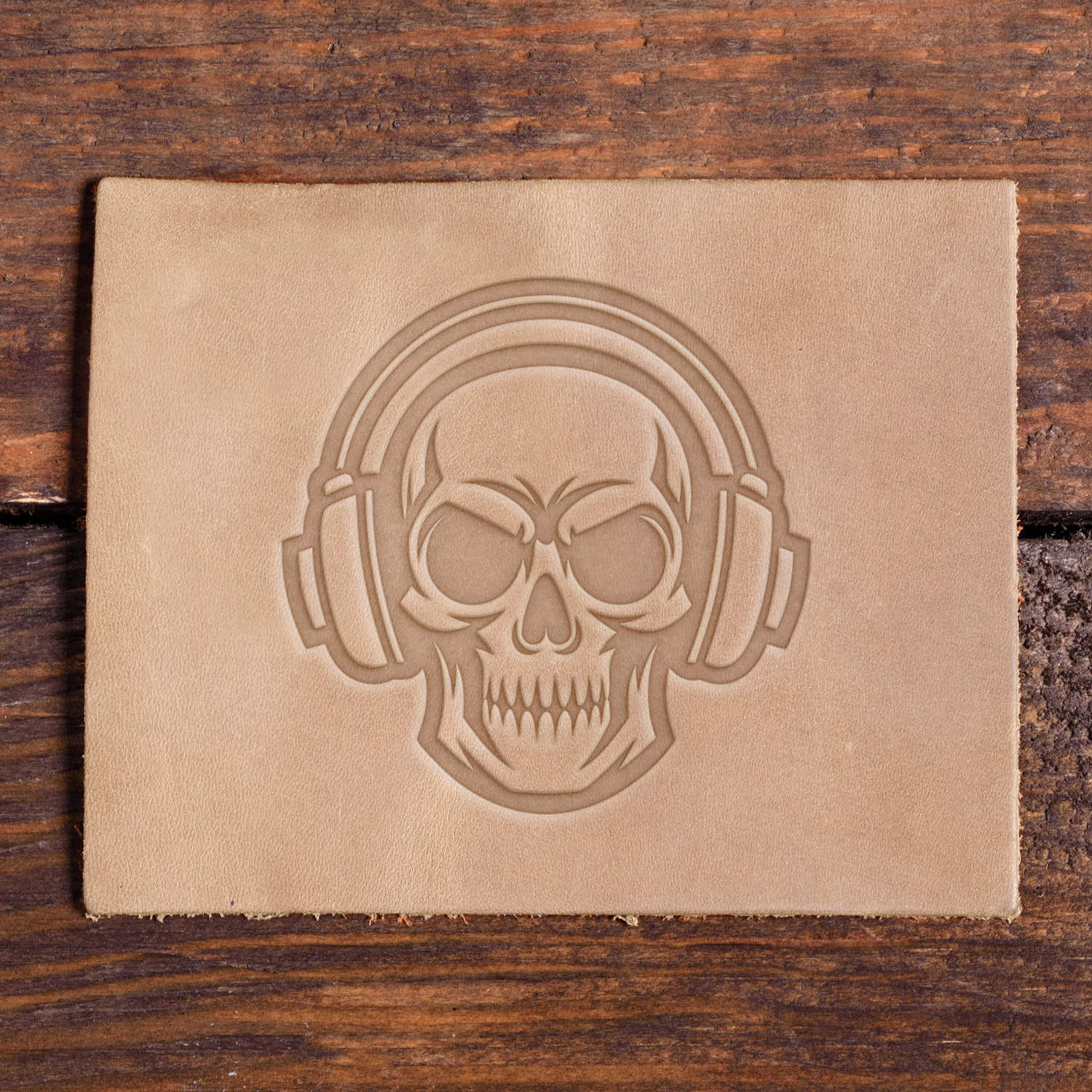 Skull wearing headphones stamped into leather using a Delrin leather stamp.