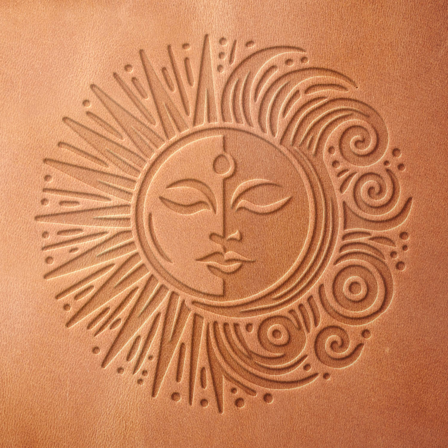 Leather sample with a stamped sun and moon impression, adding a celestial and artistic touch to leather designs.