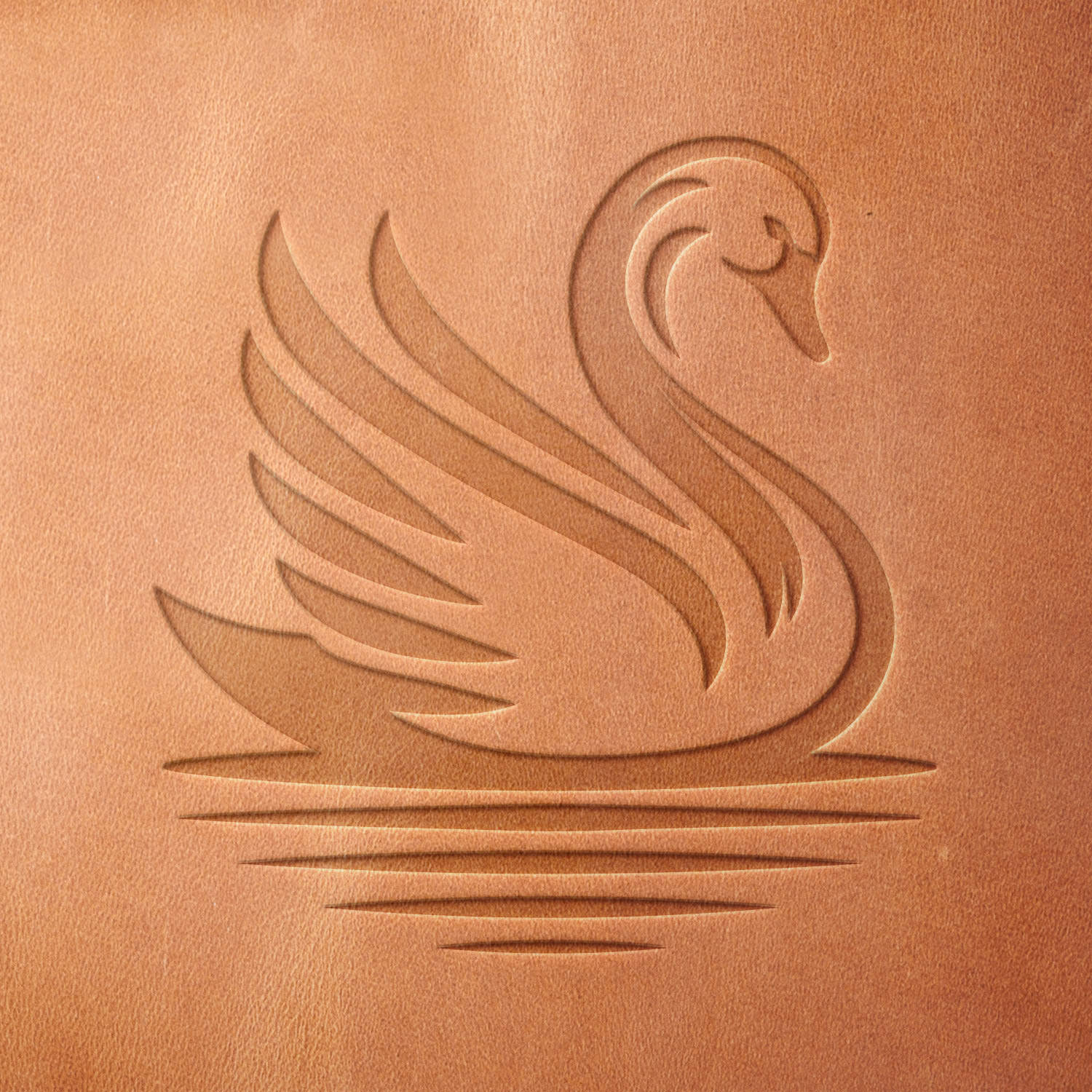 Leather piece stamped with a Delrin leather stamp of a swan gliding on water—adds a refined and serene detail to handmade journals, wallets, or keepsakes.
