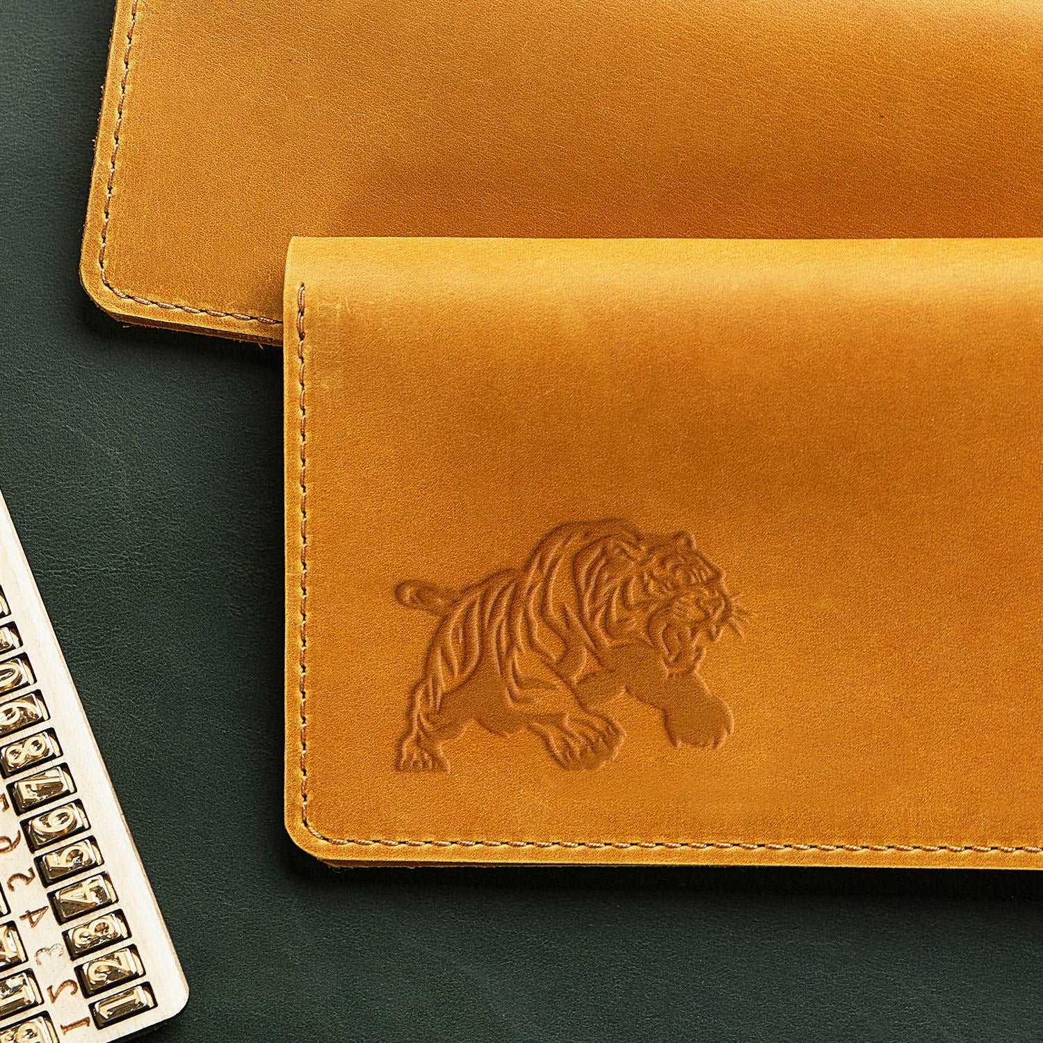 Leather wallet featuring a crouching tiger design stamped with a Delrin tool, perfect for creating wildlife and fierce animal-themed leather crafts
