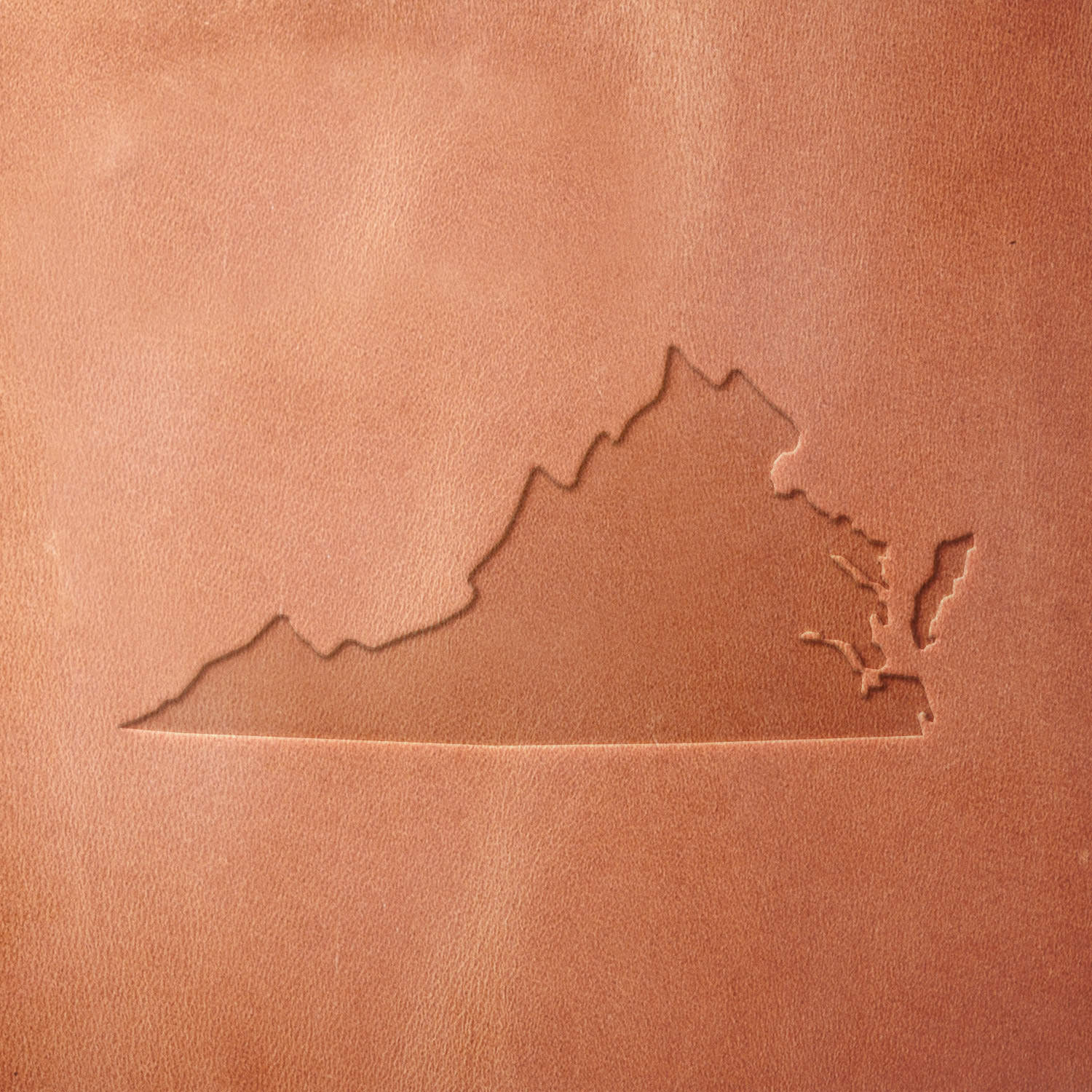 Leather sample featuring a stamped Virginia state silhouette using a Delrin leather stamp, perfect for custom leather goods, souvenirs, and regional artwork.