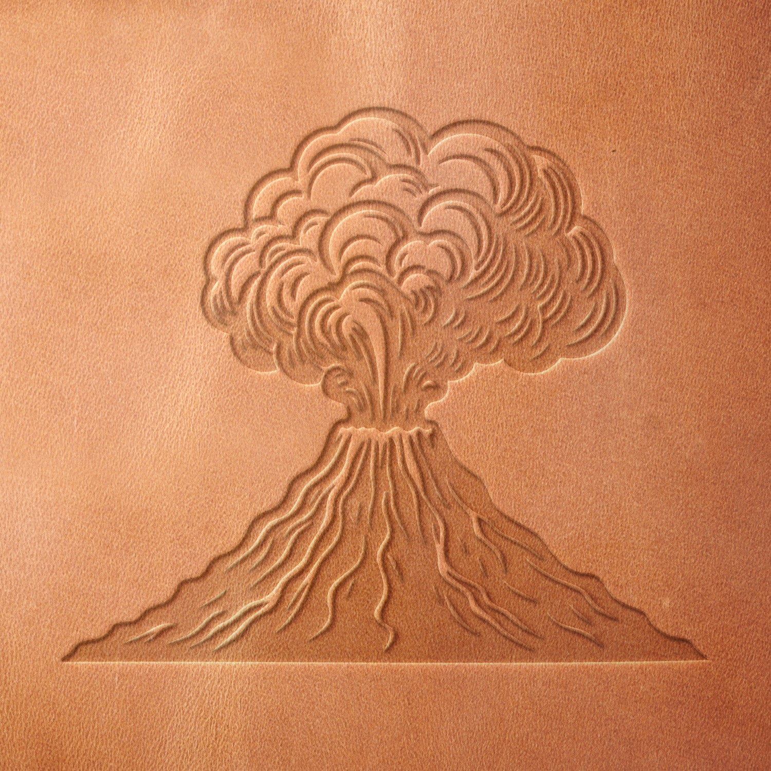 Leather sample with a crisp volcano eruption stamp impression, adding dramatic texture to nature-inspired leather designs.