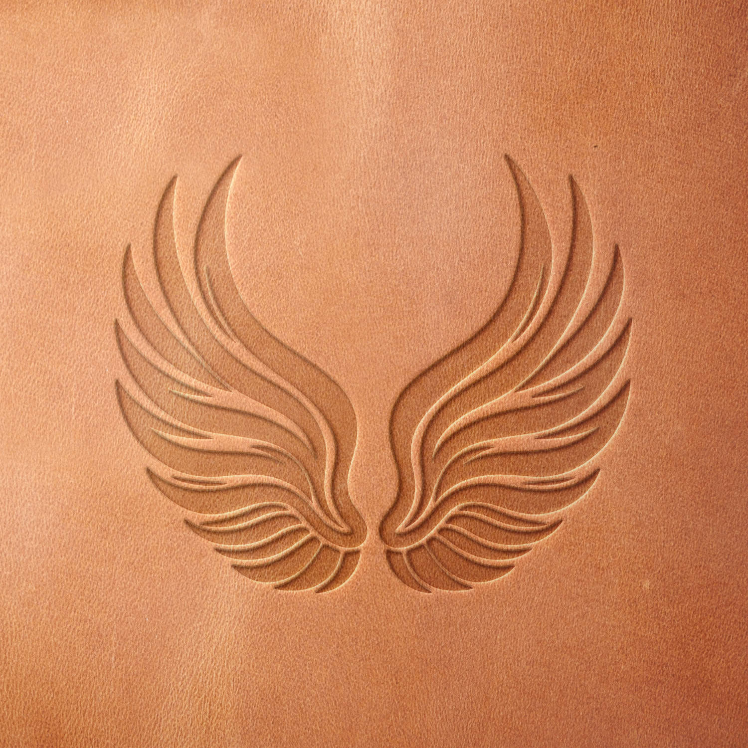 Leather piece stamped with a Delrin leather stamp featuring elegant outstretched wings—ideal for journals, memorial gifts, or fantasy-inspired leather projects.