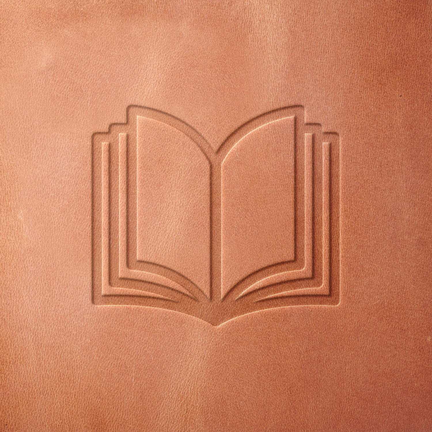 Leather sample featuring a stamped open book design, created using a Delrin leather stamp—perfect for book lovers, educators, and custom leather goods.