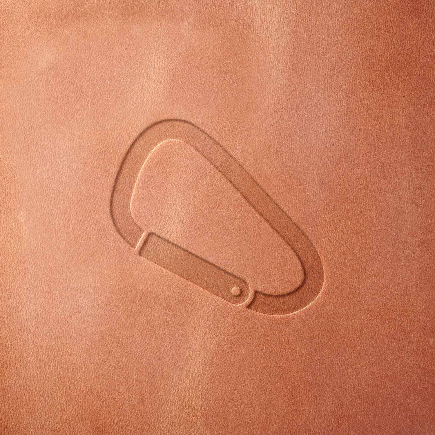 Leather sample featuring a stamped carabiner design, created using a Delrin leather stamp—perfect for adventure, hiking, and tactical gear applications.