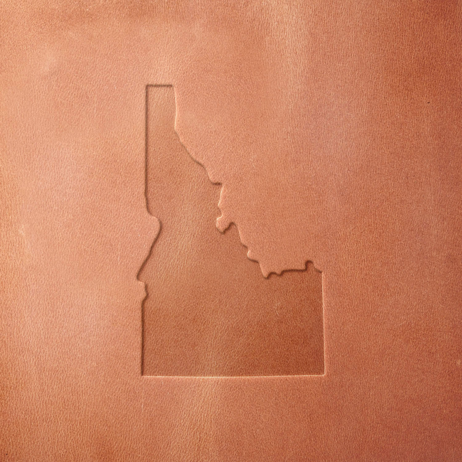 Leather sample featuring a stamped Idaho state outline, crafted with a Delrin leather stamp—perfect for showcasing Idaho pride on wallets, keychains, and handmade goods.