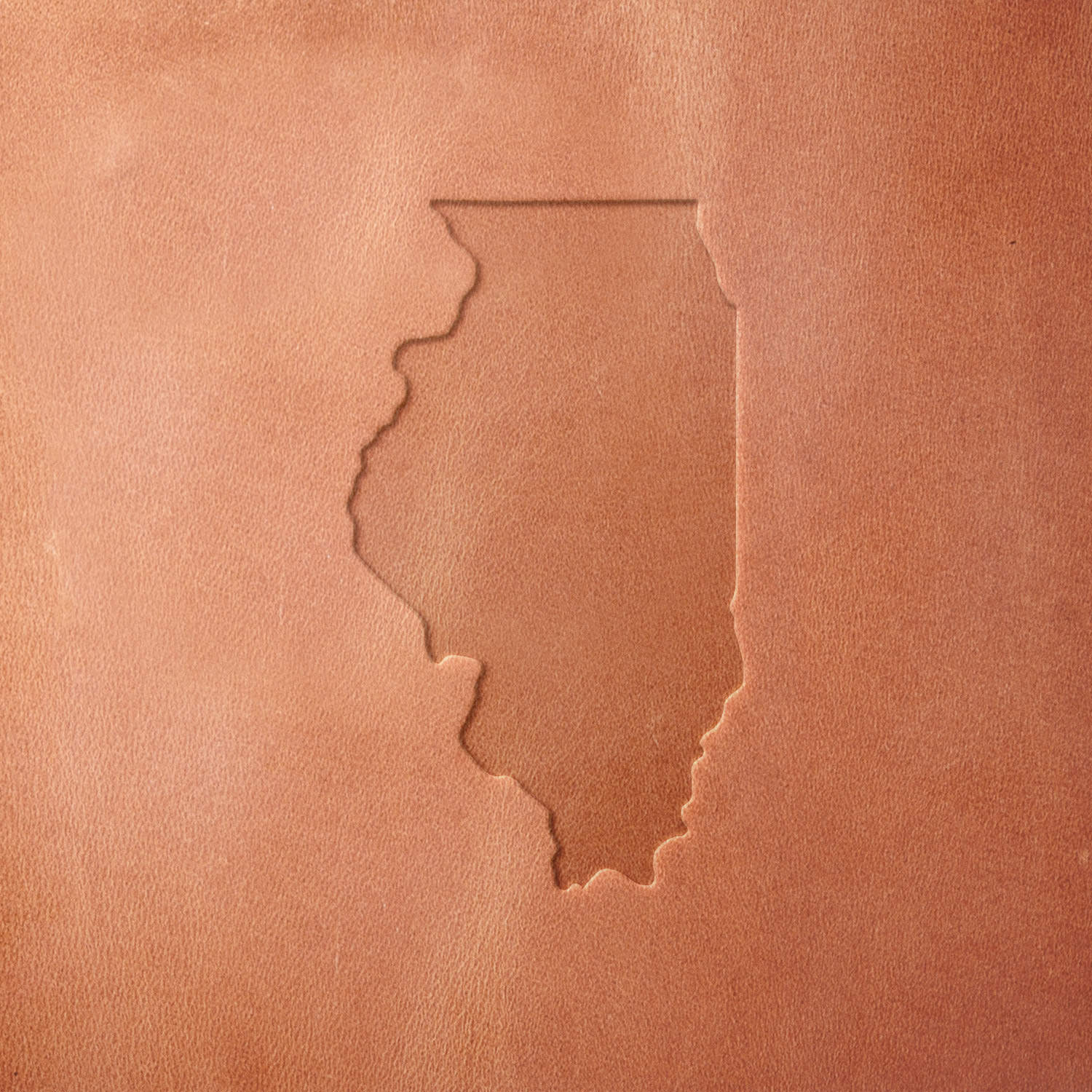 Leather sample featuring a stamped Illinois state outline, crafted using a Delrin leather stamp—ideal for personalized leather goods, travel accessories, and handcrafted keepsakes.