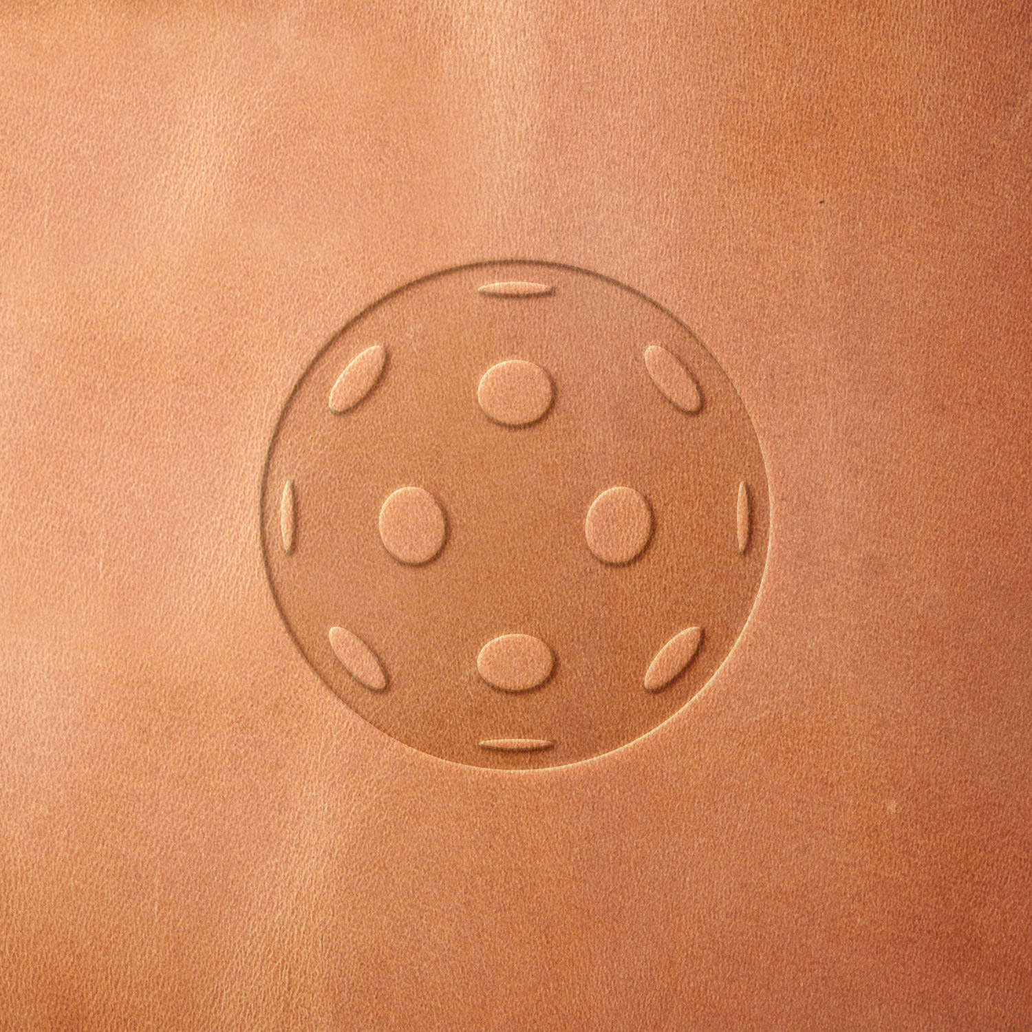 Leather sample featuring a stamped pickleball design, created using a Delrin leather stamp—ideal for fans of the sport and custom leather projects.