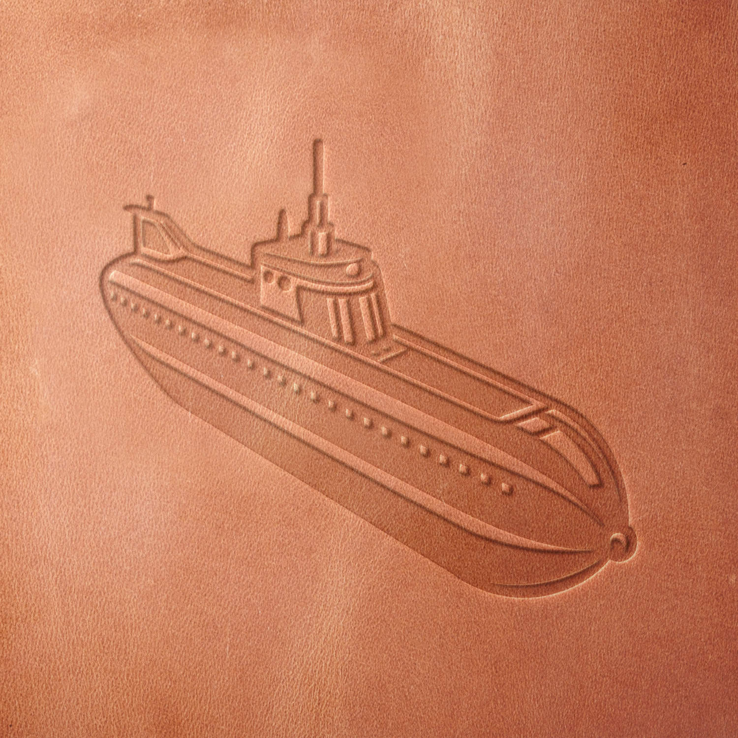 Leather sample featuring a stamped submarine design, created using a Delrin leather stamp—perfect for military, naval, and underwater exploration themes.