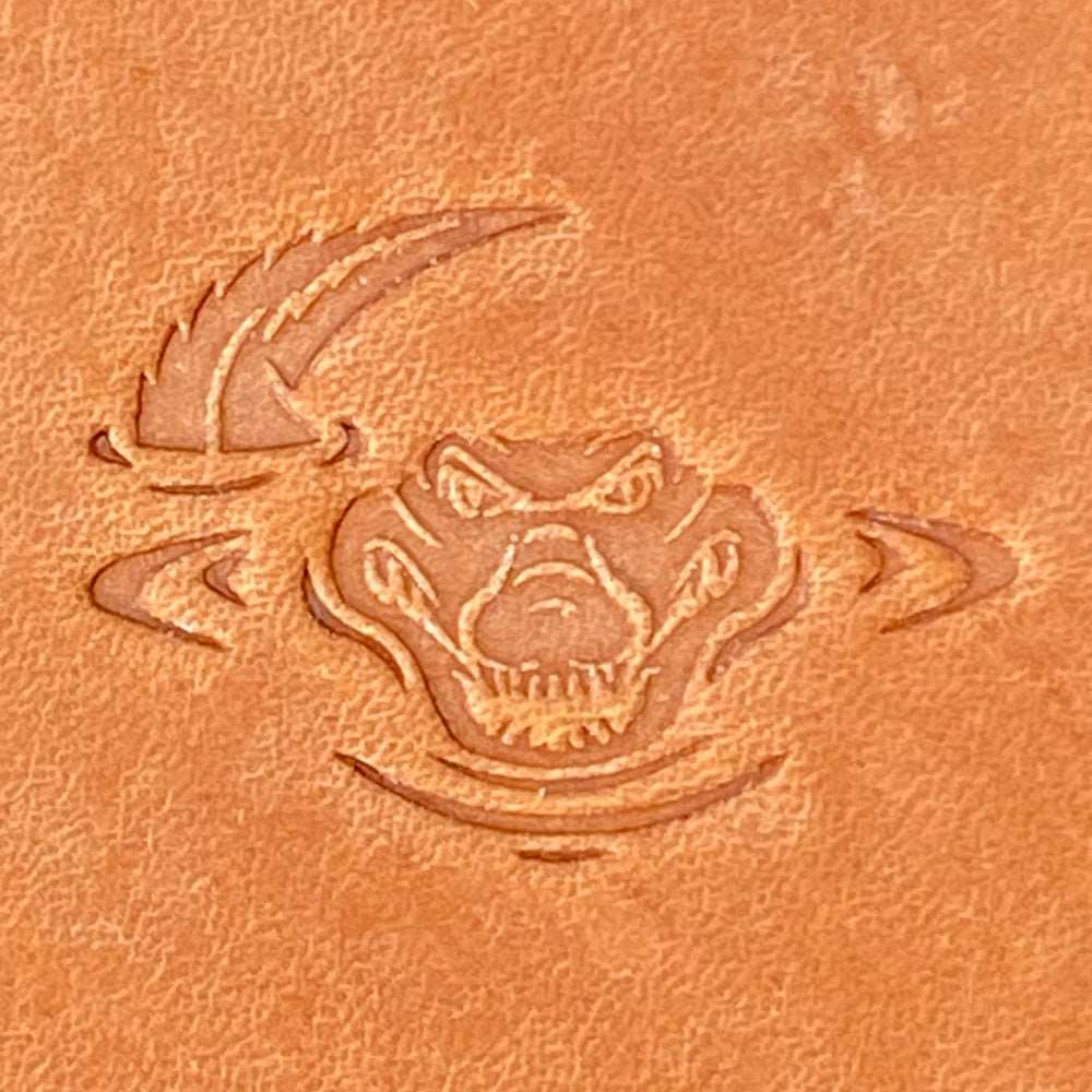 Imprint of an alligator in water leather stamp made from Delrin on leather, detailed and fierce design