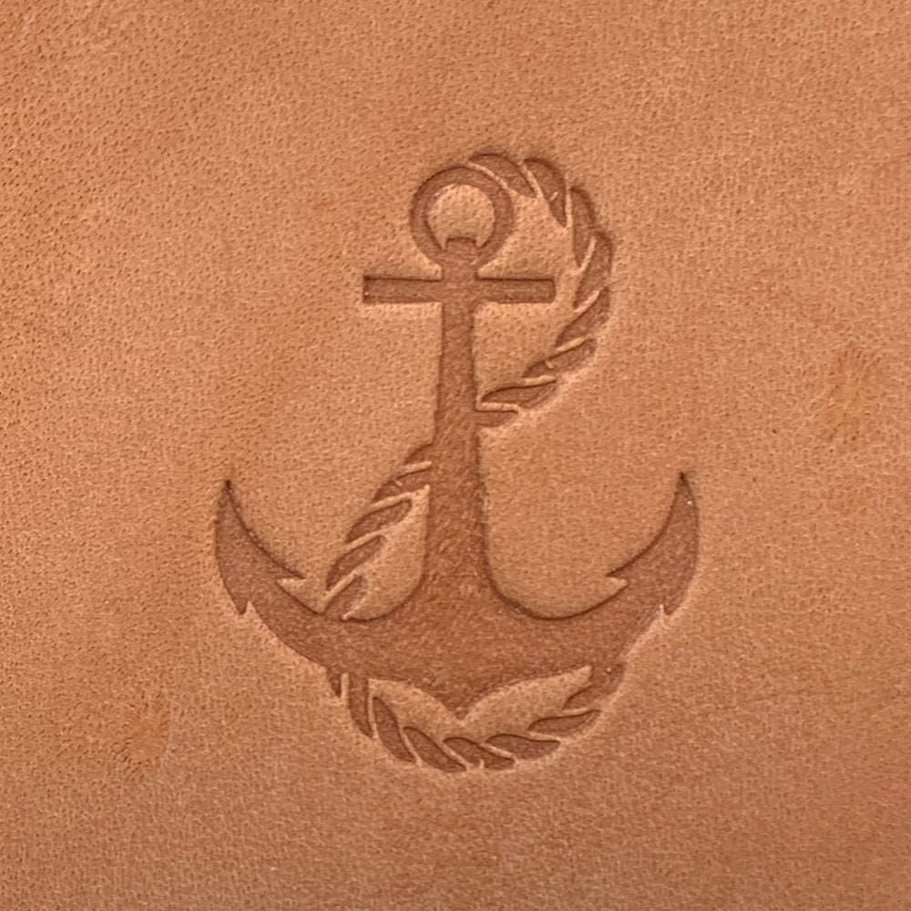 Imprint of an anchor with rope leather stamp made from Delrin on leather, nautical and classic sailing design