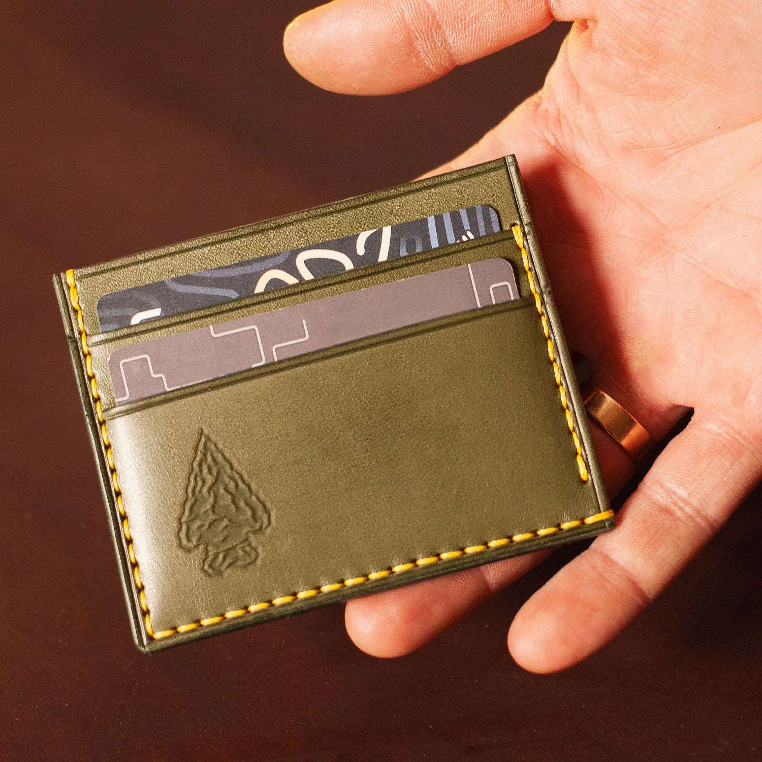 Leather wallet with an imprint of an arrowhead, crafted using a Delrin stamp, perfect for rustic and outdoor enthusiasts