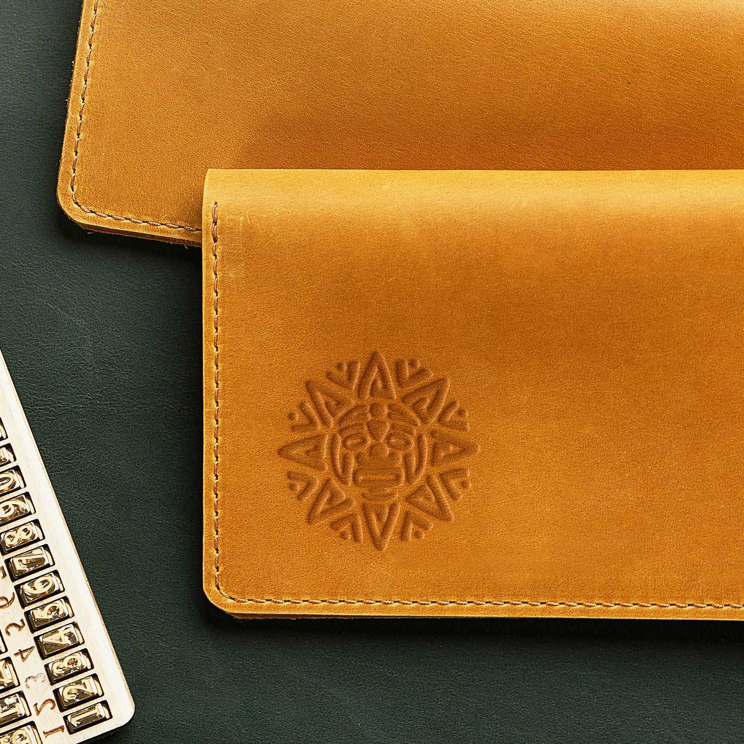 Leather product with sun face design stamped using a Delrin tool, ideal for cultural and artisan crafts