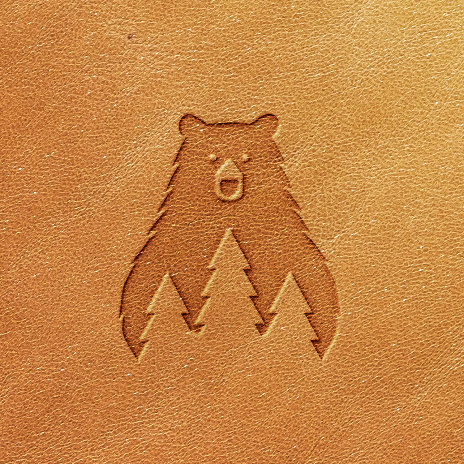 Embossed design on leather using the Bear with Pine Trees Delrin Leather Stamp.