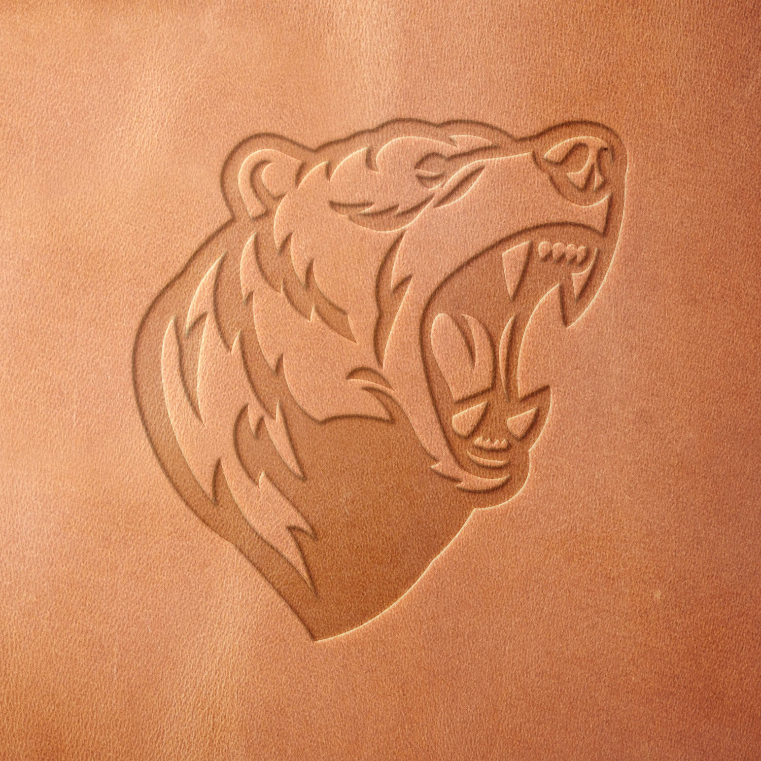 Leather sample with a crisp roaring bear stamp impression from a Delrin leather stamp, ideal for creating high-quality wildlife and outdoor-themed leathercraft projects.