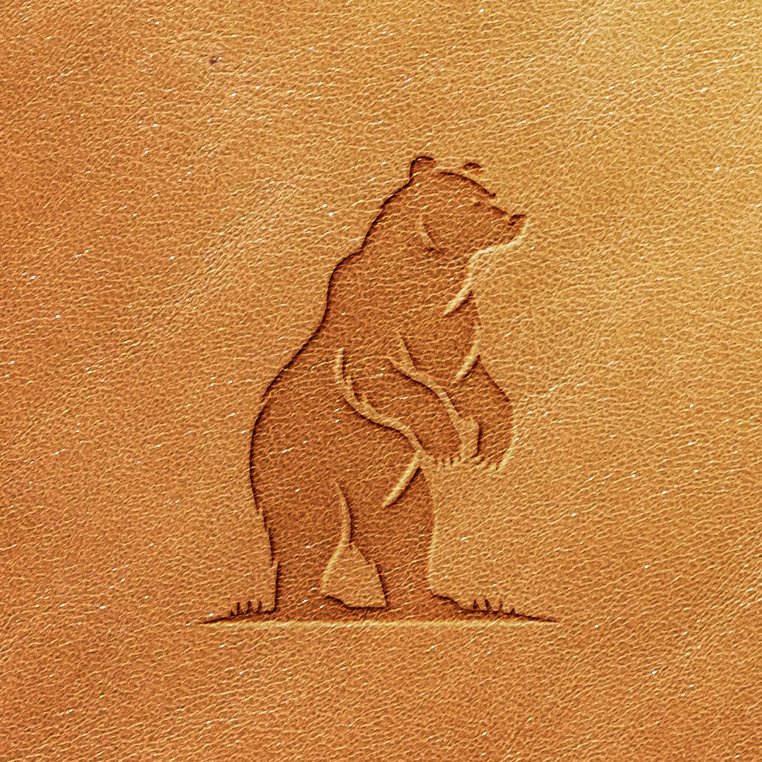 The Standing Bear Delrin Leather Stamp showcases a bear standing on its hind legs, with slightly bent front legs, depicted from a side profile. The textured light brown background enhances the rustic appeal.