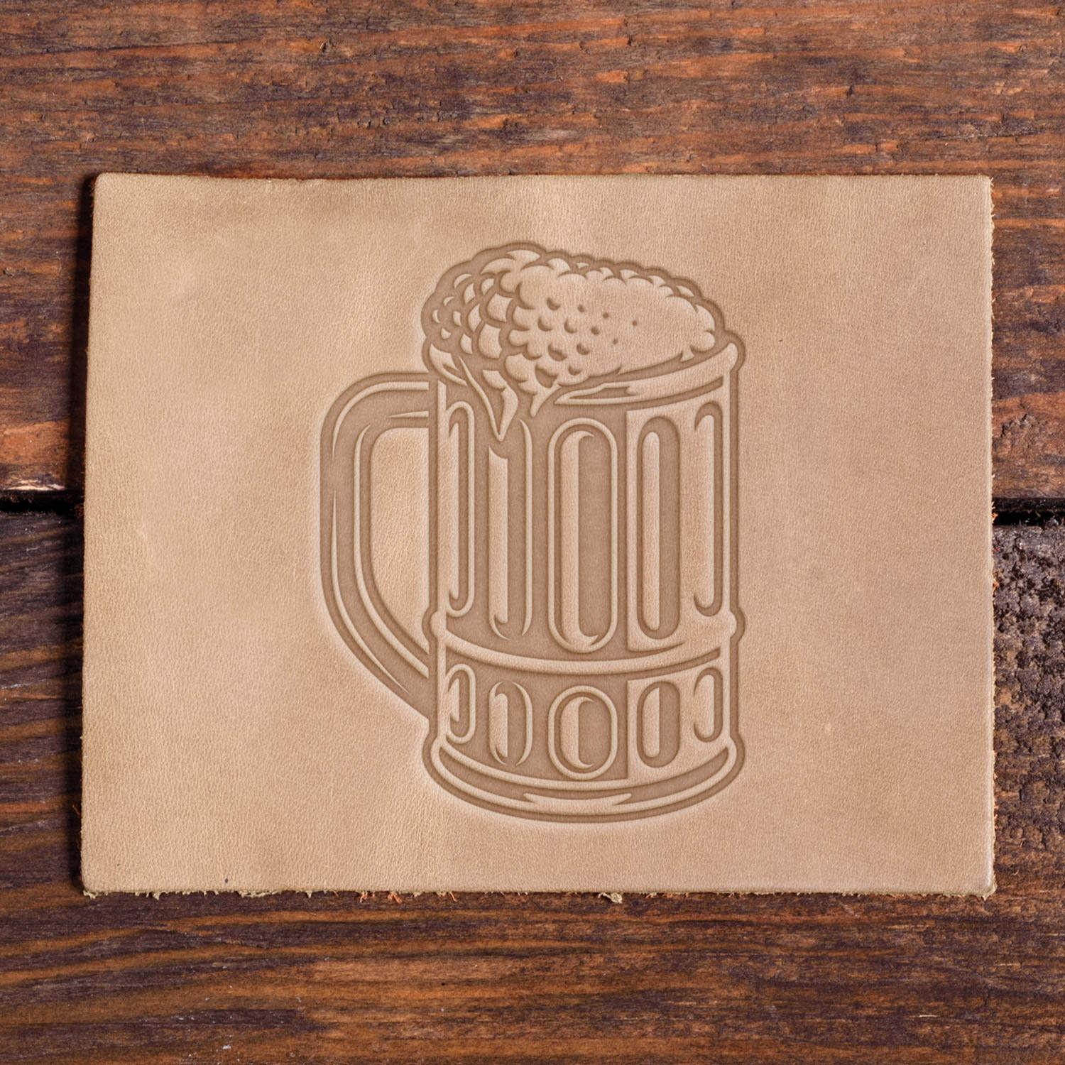 Classic beer mug with foamy top stamped cleanly into leather using a Delrin leather stamp.