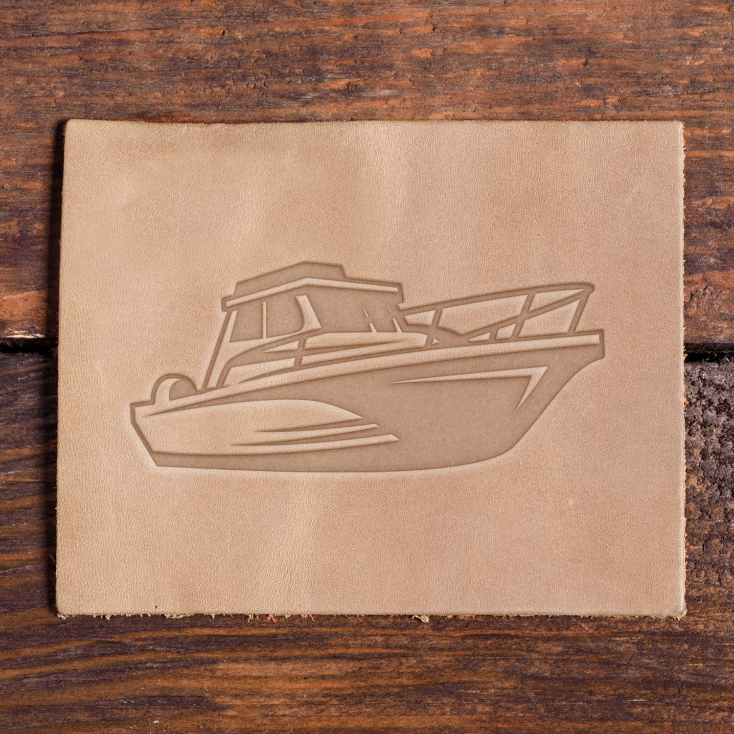 Leather sample with a stamped fishing boat design using a Delrin leather stamp.