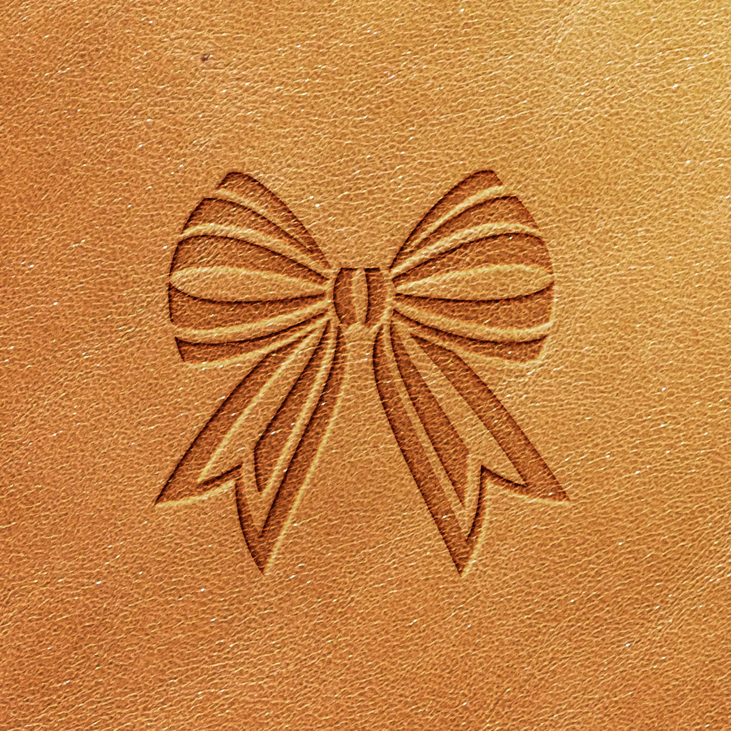 A close-up image of the Bow Delrin Leather Stamp on a brown leather surface, featuring an embossed design of a decorative bow with two symmetrical loops and two ribbon tails. The fine grain patterns of the leather texture are also visible.