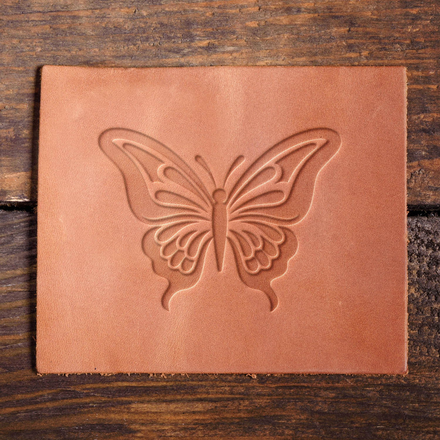 Leather sample with a crisp butterfly stamp impression from a Delrin leather stamp, ideal for creating high-quality nature and floral-themed leathercraft projects.