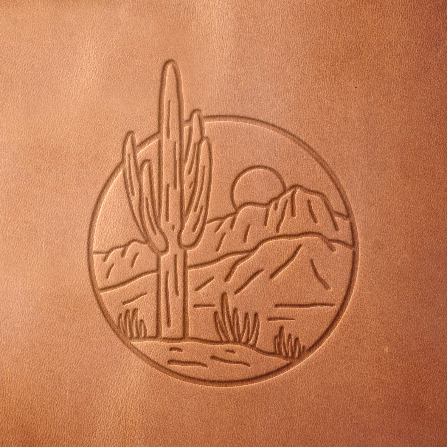 Leather sample with a crisp desert cactus and mountain landscape stamp impression from a Delrin leather stamp, ideal for creating high-quality southwestern and nature-themed leathercraft projects.