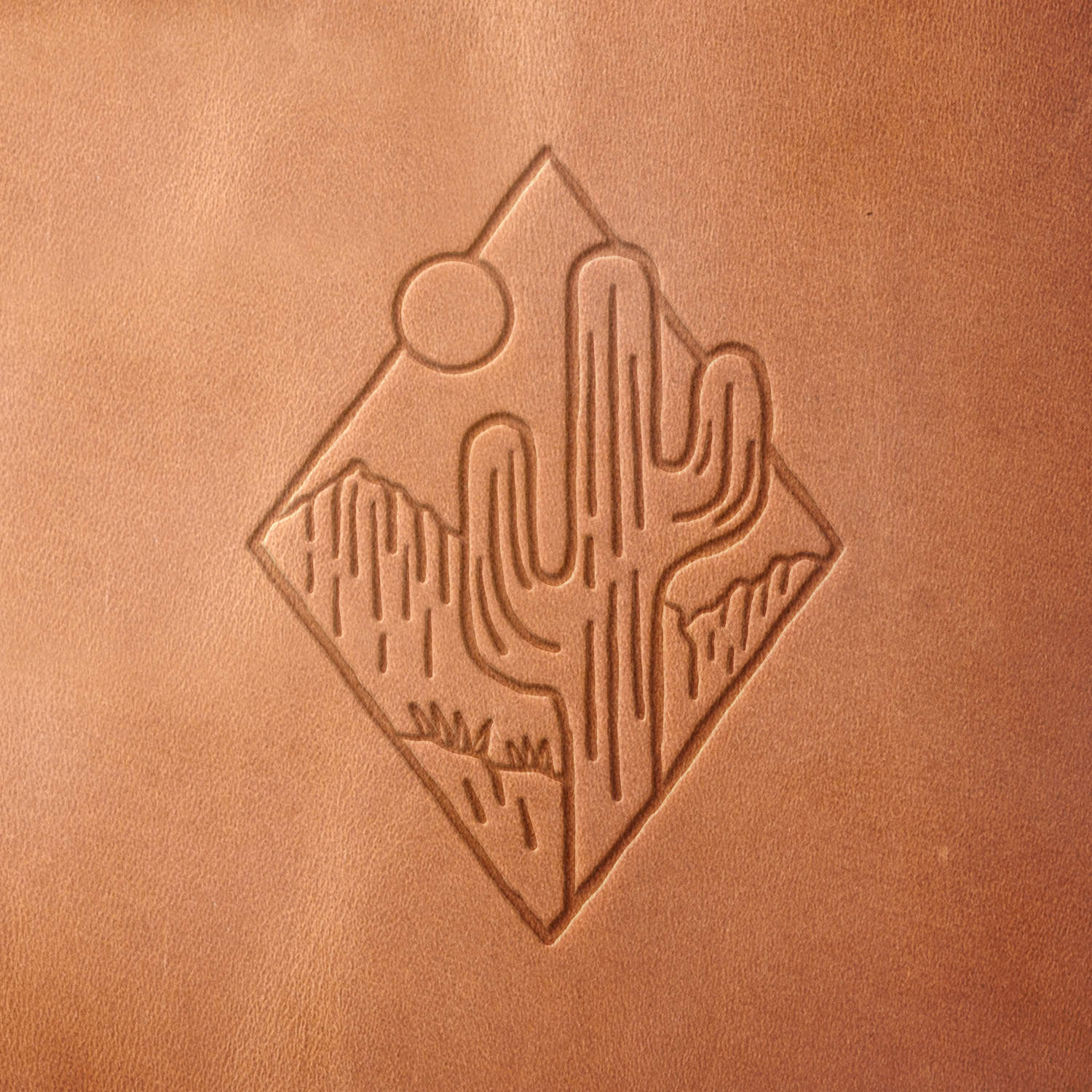 Leather sample with a crisp desert cactus landscape stamp impression from a Delrin leather stamp, ideal for creating high-quality southwestern and nature-themed leathercraft projects.