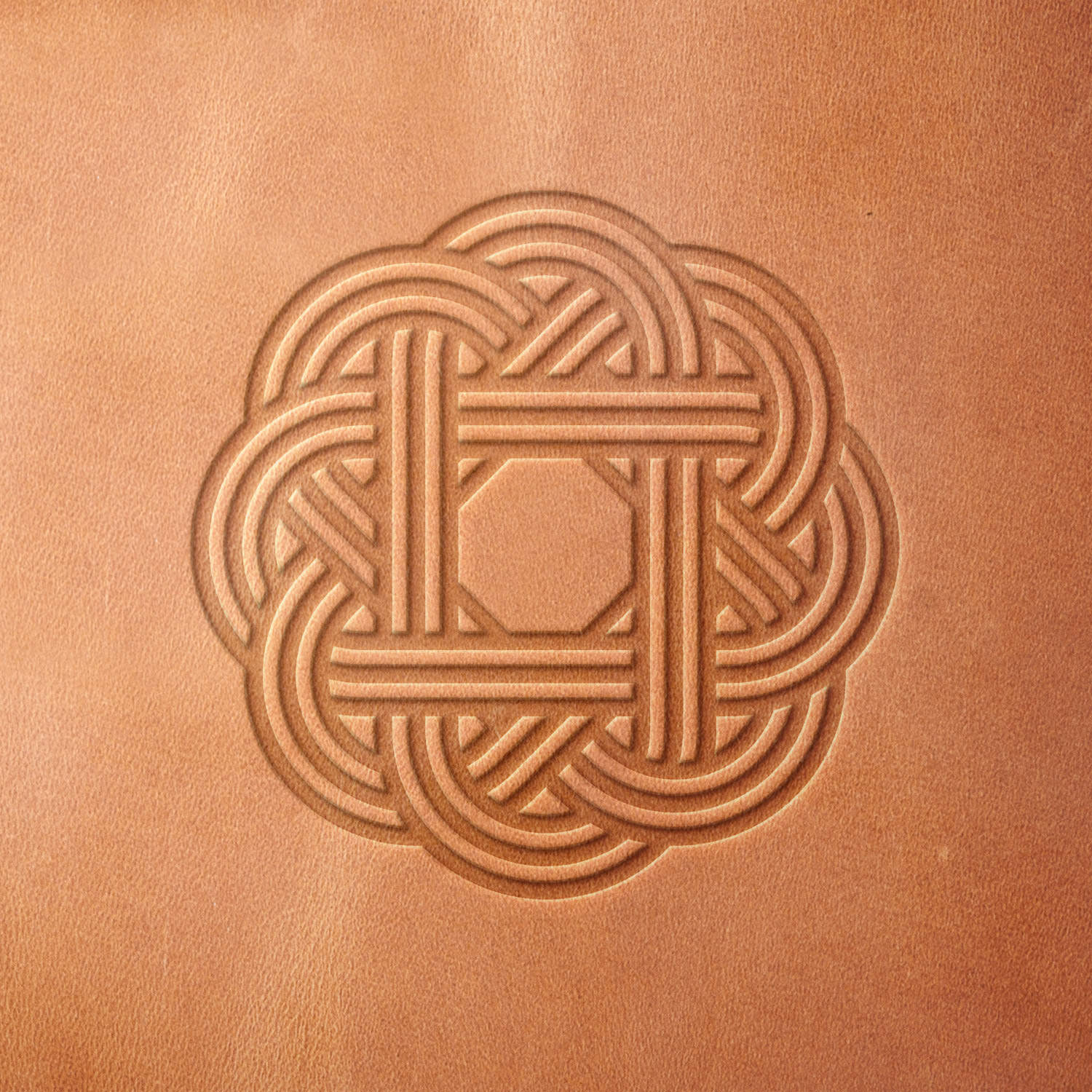 Leather sample showcasing a stamped Celtic knot design using a delrin leather stamp, highlighting the design’s braided details and balanced geometry.