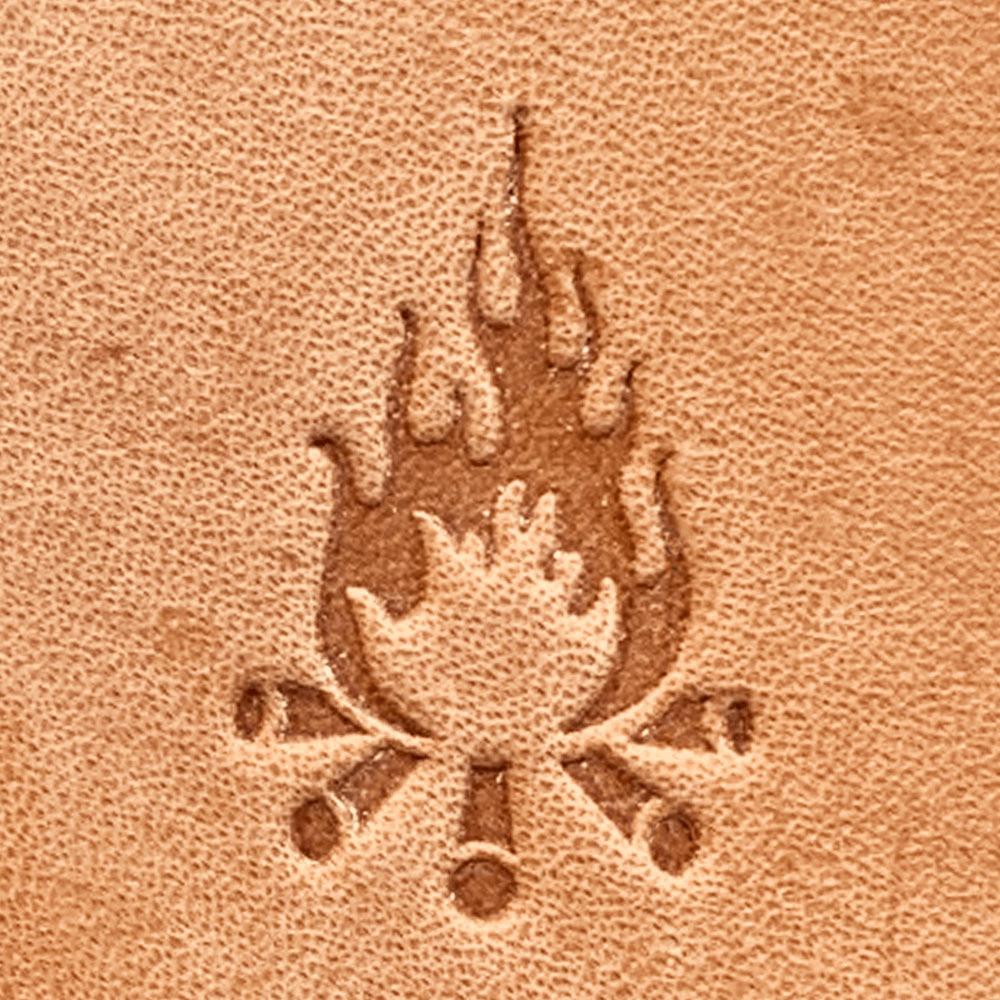 Stamped impression of a campfire with crossed logs made using a Delrin leather stamp on natural veg-tan leather.