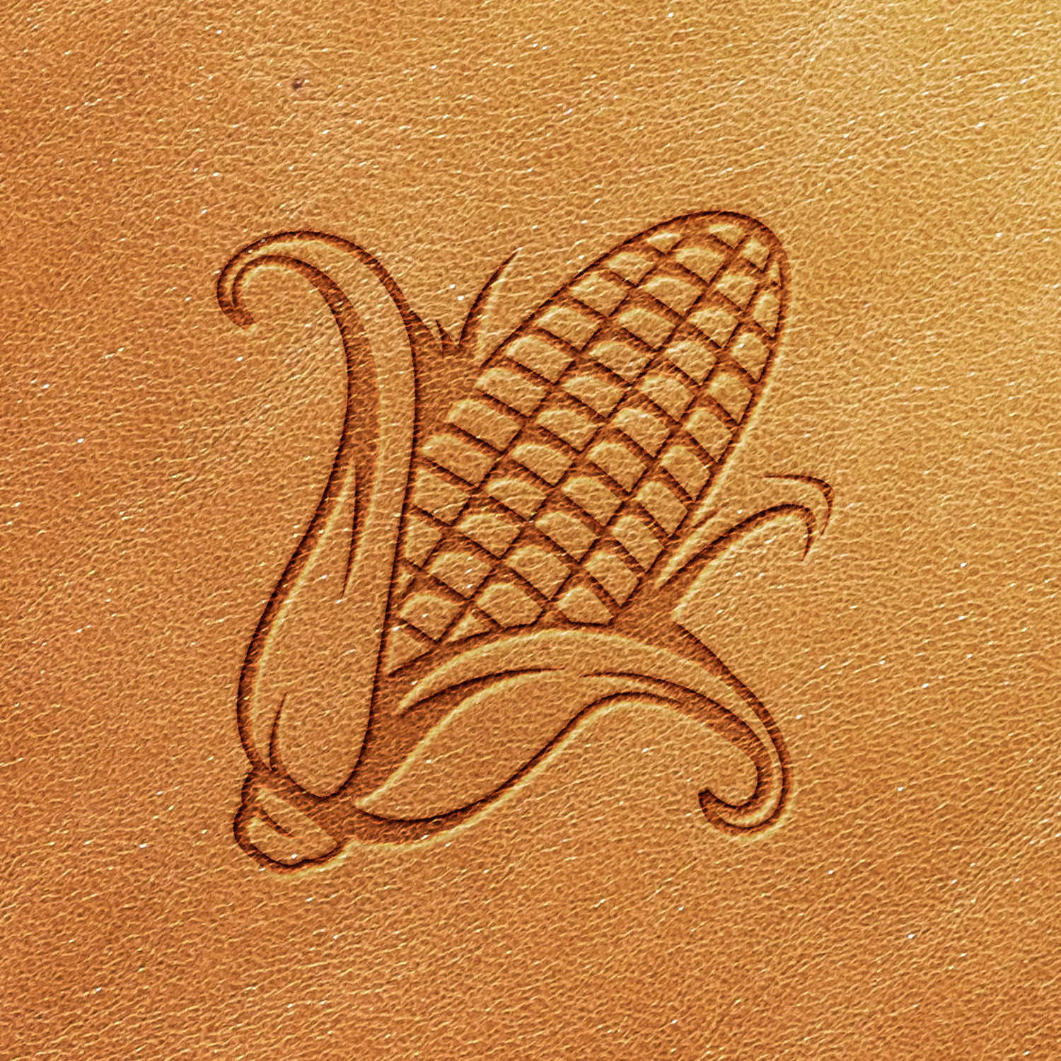 The Corn Delrin Leather Stamp features a detailed, stylized engraving of an ear of corn with its husk on a tan leather surface, showcasing the texture of the corn kernels and the graceful curves of the husk.