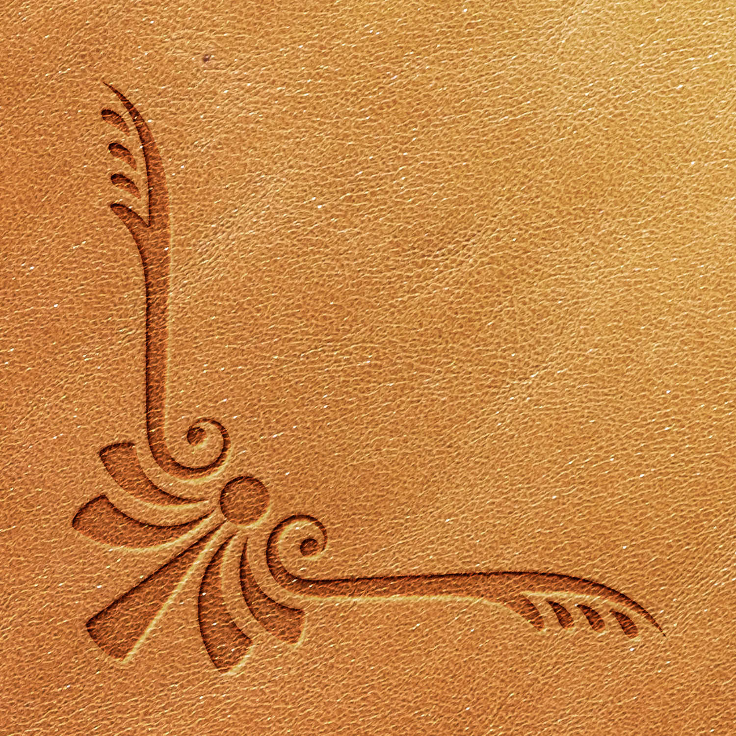 An intricate close-up of the light brown textured leather reveals an embossed decorative pattern created using the Corner Delrin Leather Stamp. The design features swirling lines and feather-like elements that gracefully converge towards a central point, forming an ornate flourish in one corner.