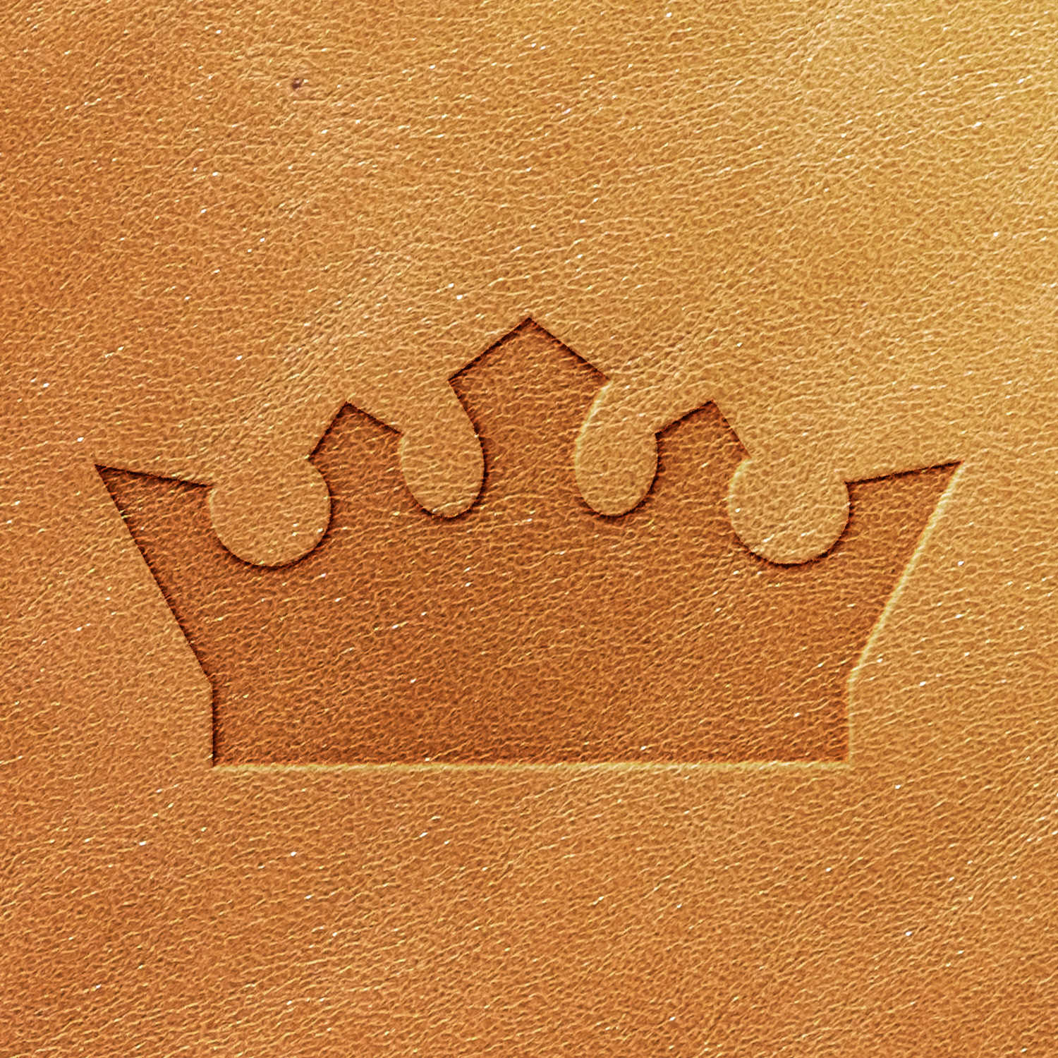 This is the Crown Delrin Leather Stamp, featuring a brown leather surface embossed with a crown symbol in the center. The crown has five points with rounded tops, and the texture of the leather is clearly visible in the image.