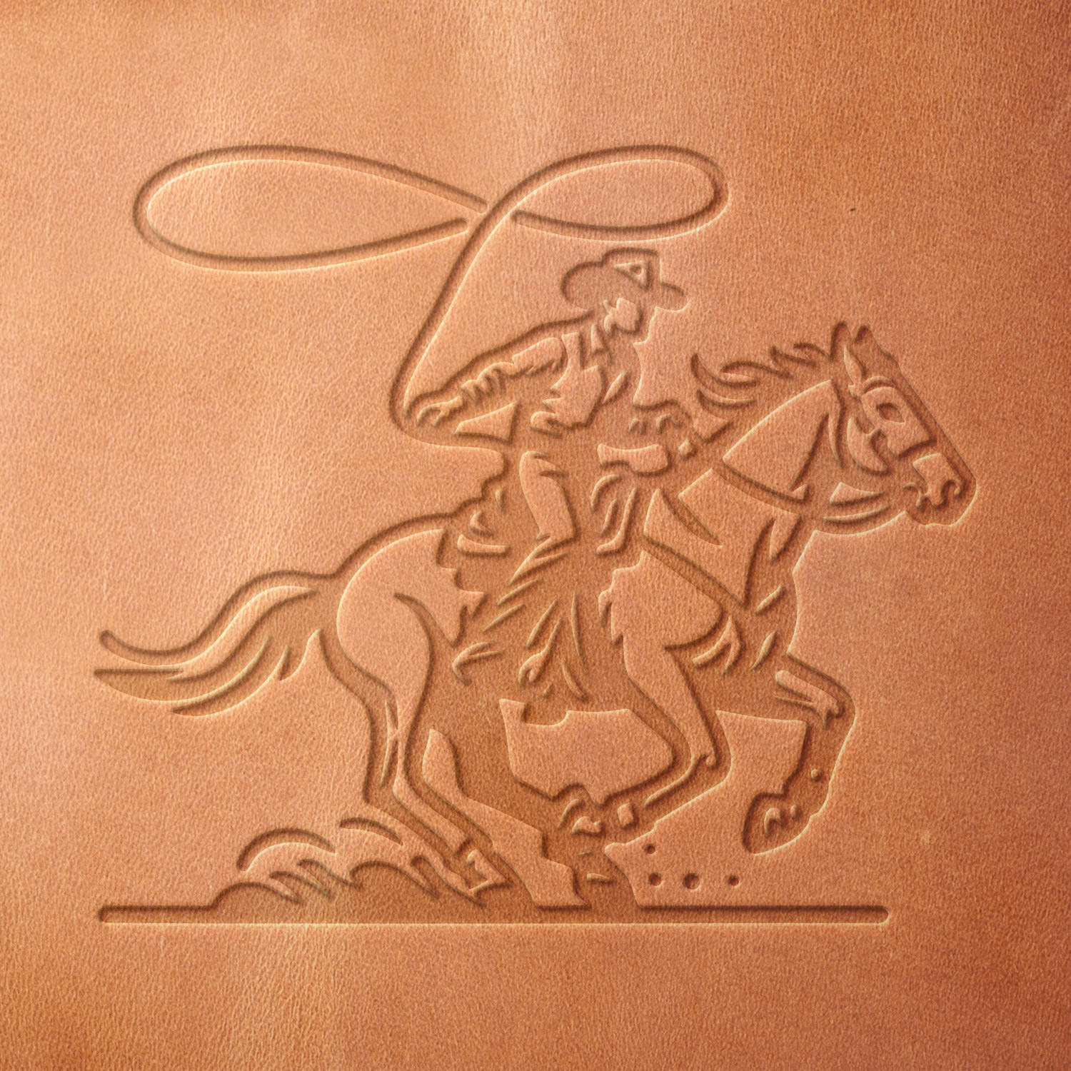 Leather sample with a stamped impression of a cowboy roping a horse, perfect for Western-themed leather crafts.