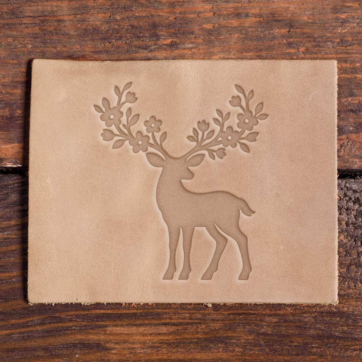 Deer with floral antlers impression stamped into veg-tan leather with a Delrin leather stamp.
