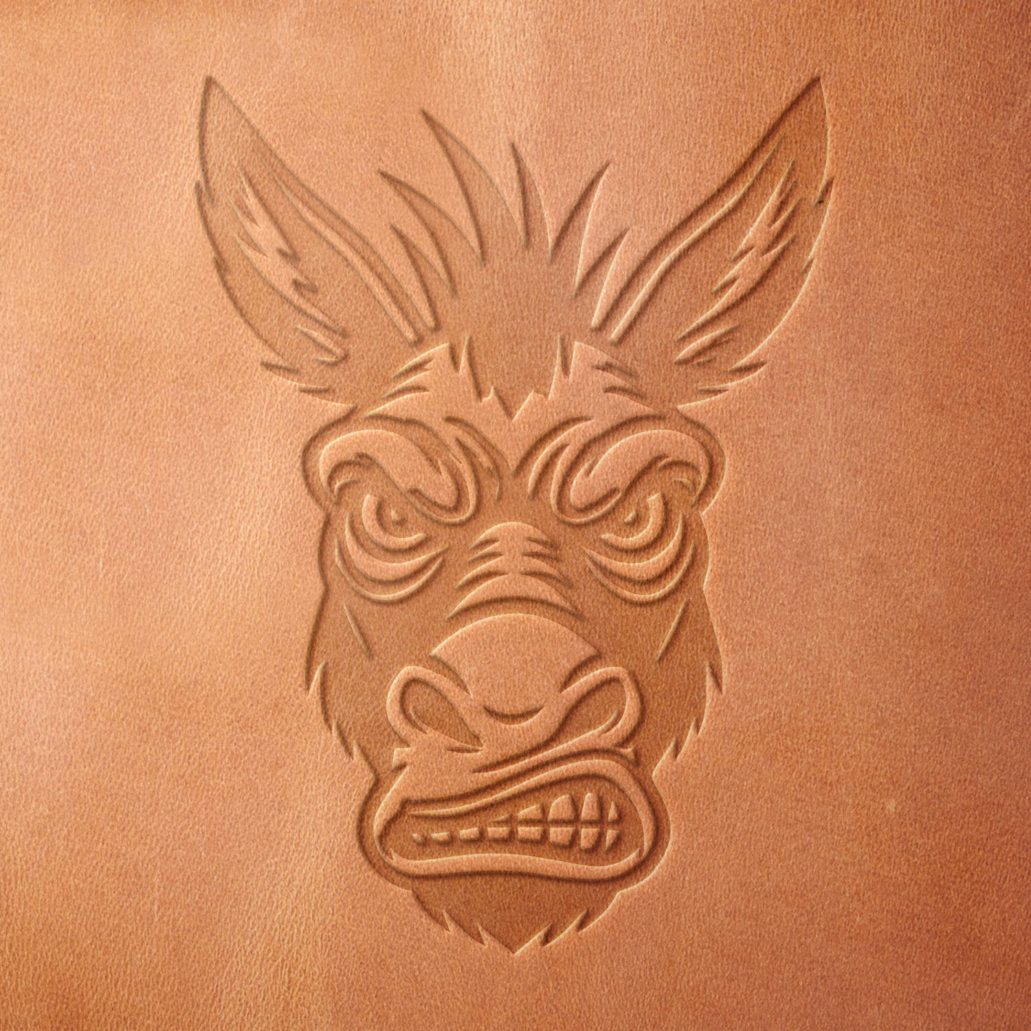 Leather sample showcasing a stamped donkey head design using a delrin leather stamp, highlighting the intense facial details and expressive ears.