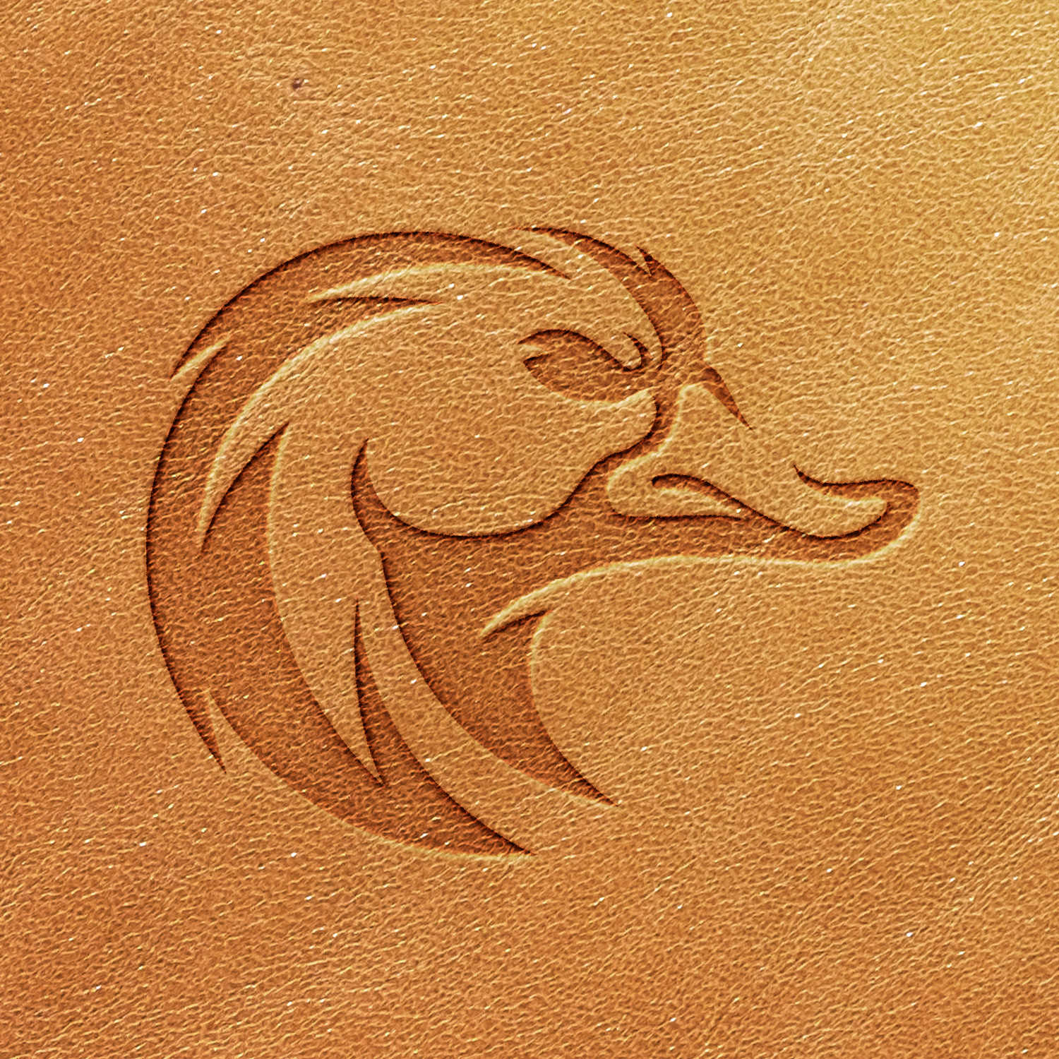 A stylized duck head is embossed using the Duck Head Delrin Leather Stamp on a light brown leather background. The design features smooth curves and a minimalist look, with the texture of the leather clearly visible, adding depth to the image.